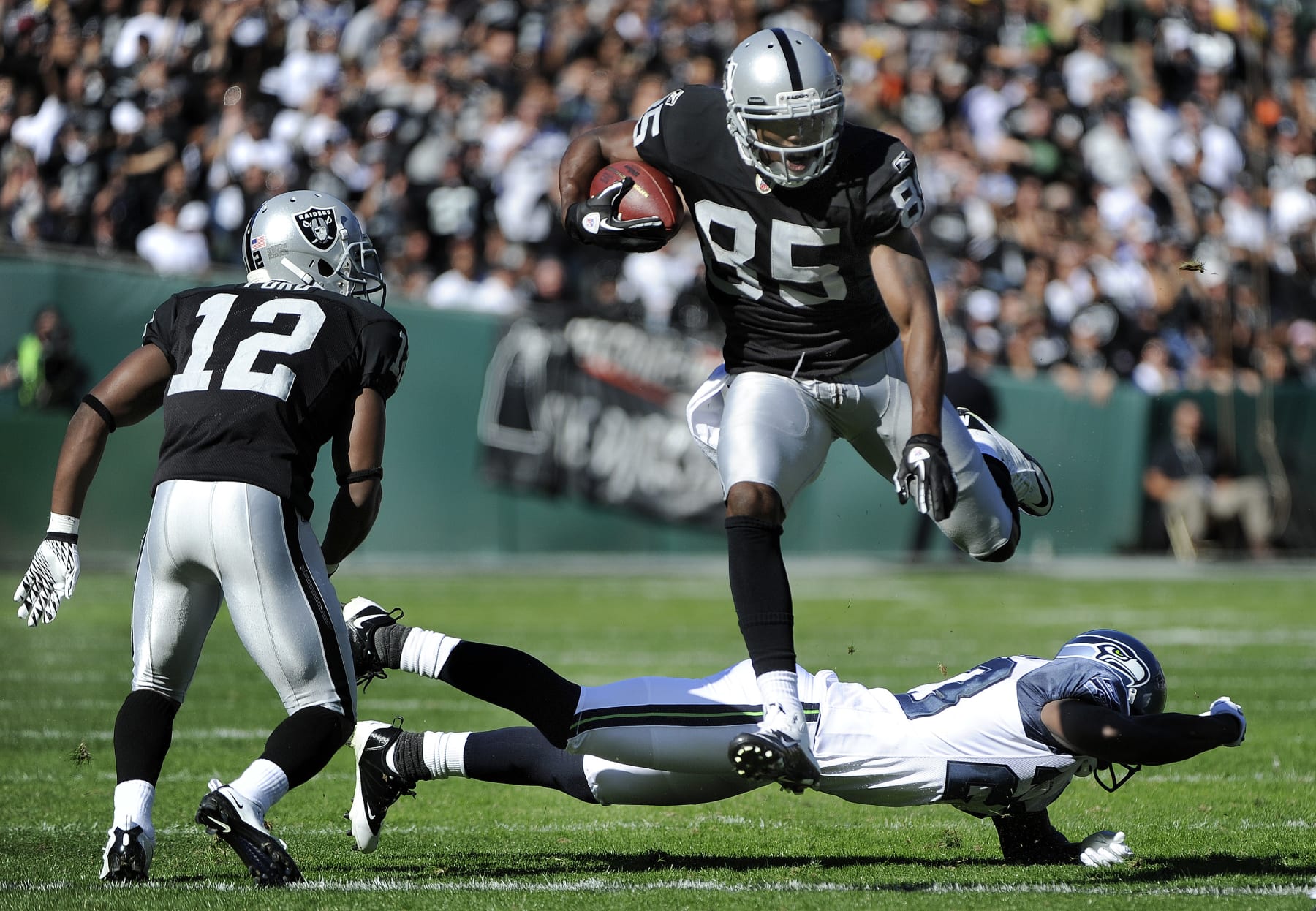OAKLAND, CA - OCTOBER 31: Darrius Heyward-Bey #85 of the Oakland Raiders leaps over would be tackler Marcus Trufant #23 of the Seattle Seahawks during an NFL football game at The Oakland-Alameda County Coliseum October 31, 2010 in Oakland, California.  (Photo by Thearon W. Henderson/Getty Images)
