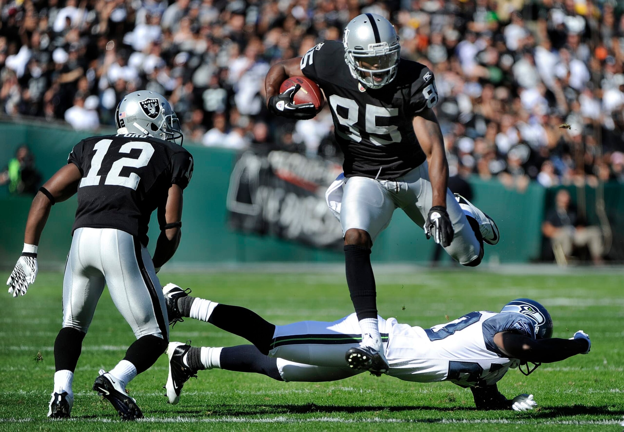 OAKLAND, CA - OCTOBER 31: Darrius Heyward-Bey #85 of the Oakland Raiders leaps over would be tackler Marcus Trufant #23 of the Seattle Seahawks during an NFL football game at The Oakland-Alameda County Coliseum October 31, 2010 in Oakland, California.  (Photo by Thearon W. Henderson/Getty Images)