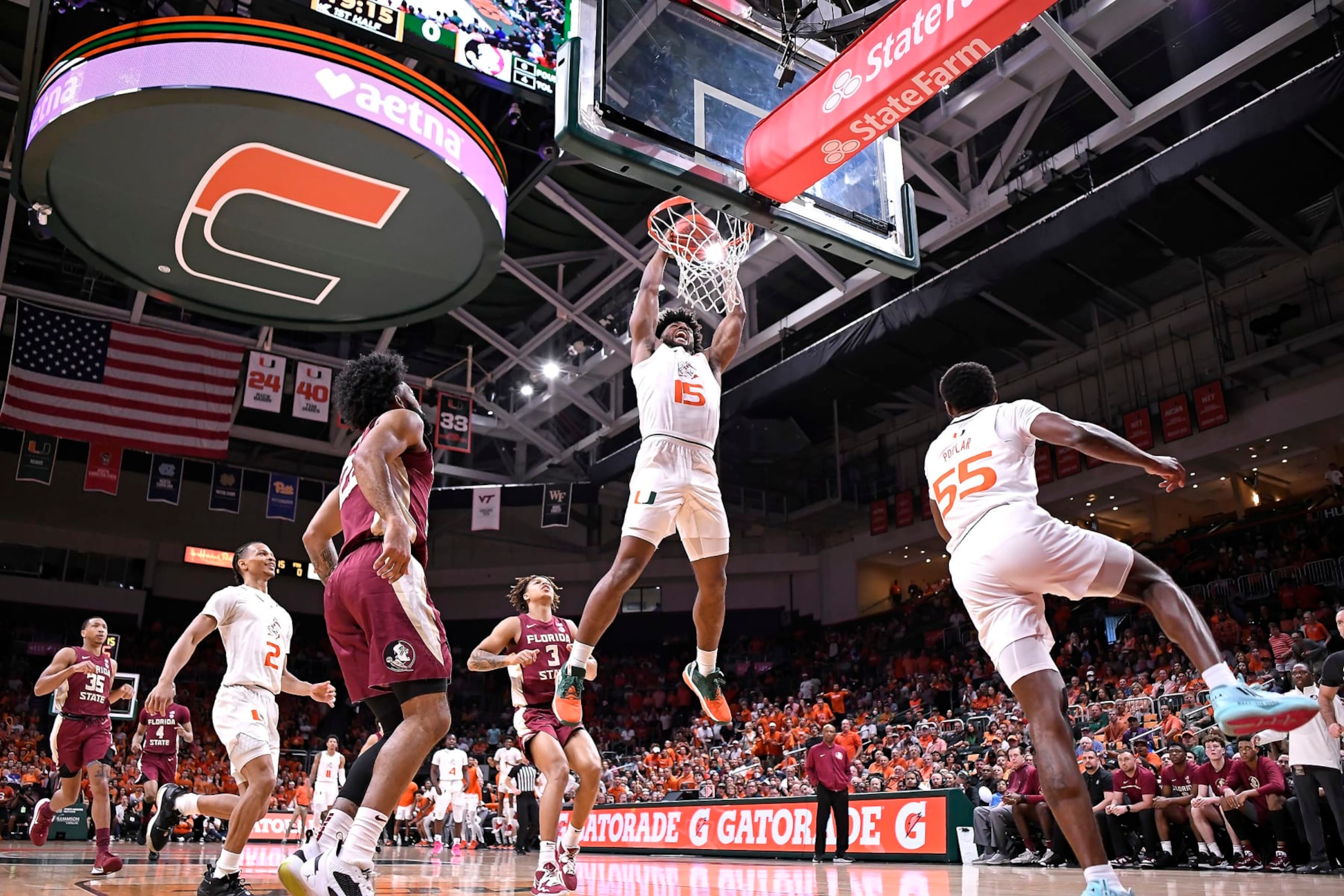CORAL GABLES, FL - FEB 25: Miami forward Norchad Omier (15) dunks the ball in the first half (also pictured, Miami guard Wooga Poplar (55), guard Isaiah Wong (2); Florida State guard Darin Green, Jr. (22), forward Cam Corhen (3), guard Matthew Cleveland (35)) as the Miami Hurricanes faced the Florida State Seminoles on February 25, 2023, at the Watsco Center in Coral Gables, Florida. (Photo by Samuel Lewis/Icon Sportswire via Getty Images) CORAL GABLES, FL - FEB 25: Miami forward Norchad Omier (15) dunks the ball in the first half (also pictured, Miami guard Wooga Poplar (55), guard Isaiah Wong (2); Florida State guard Darin Green, Jr. (22), forward Cam Corhen (3), guard Matthew Cleveland (35)) as the Miami Hurricanes faced the Florida State Seminoles on February 25, 2023, at the Watsco Center in Coral Gables, Florida. (Photo by Samuel Lewis/Icon Sportswire via Getty Images)