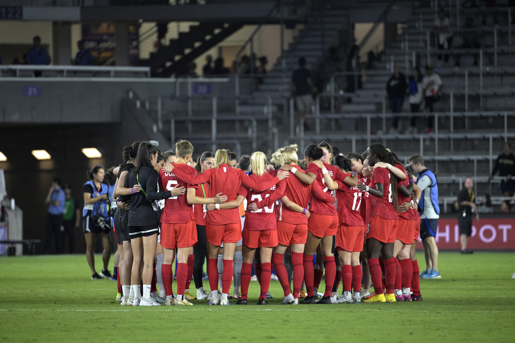 Canada players huddle on the pitch after a SheBelieves Cup women's soccer match against the United States, Thursday, Feb. 16, 2023, in Orlando, Fla. (AP Photo/Phelan M. Ebenhack)