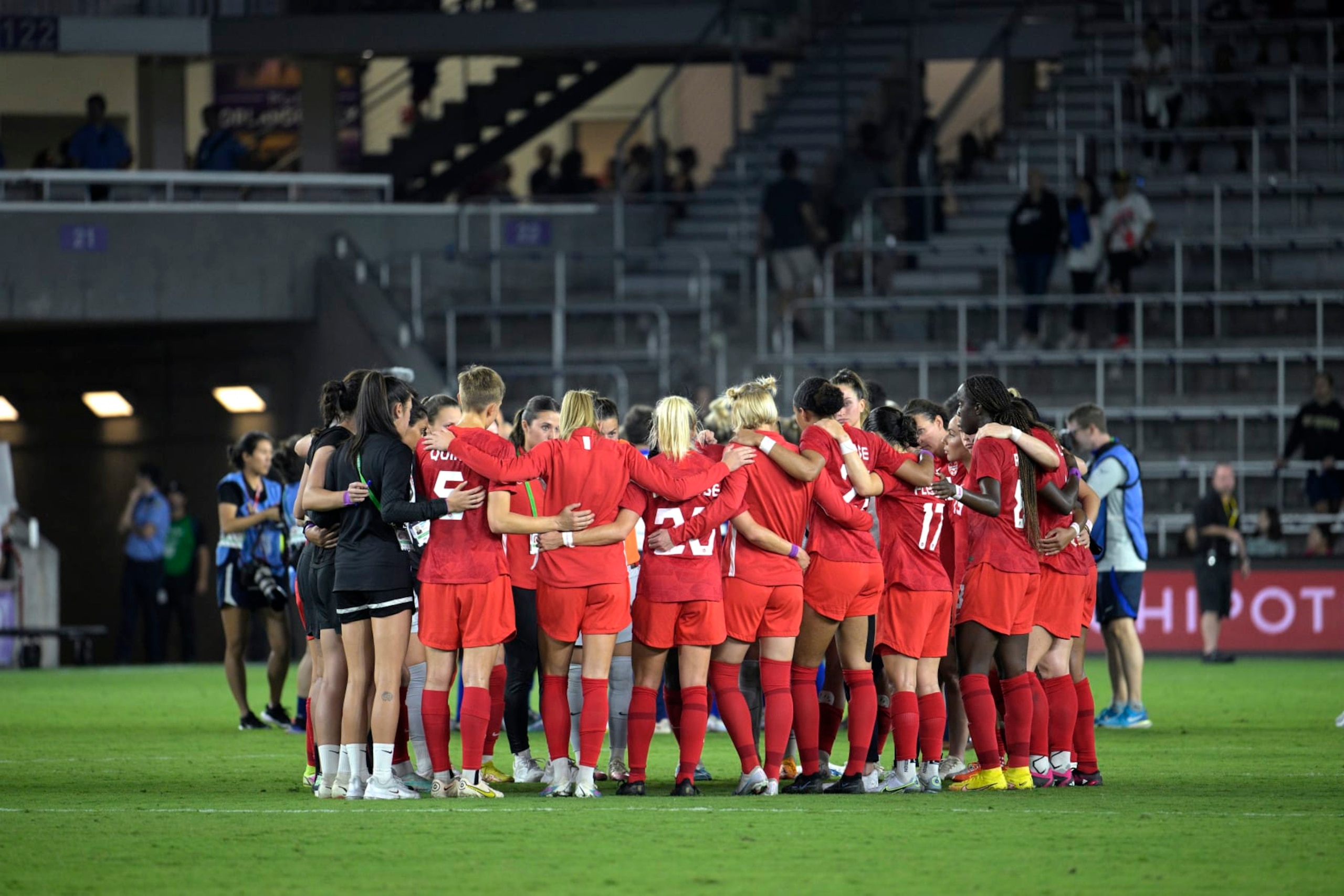 Canada players huddle on the pitch after a SheBelieves Cup women's soccer match against the United States, Thursday, Feb. 16, 2023, in Orlando, Fla. (AP Photo/Phelan M. Ebenhack)