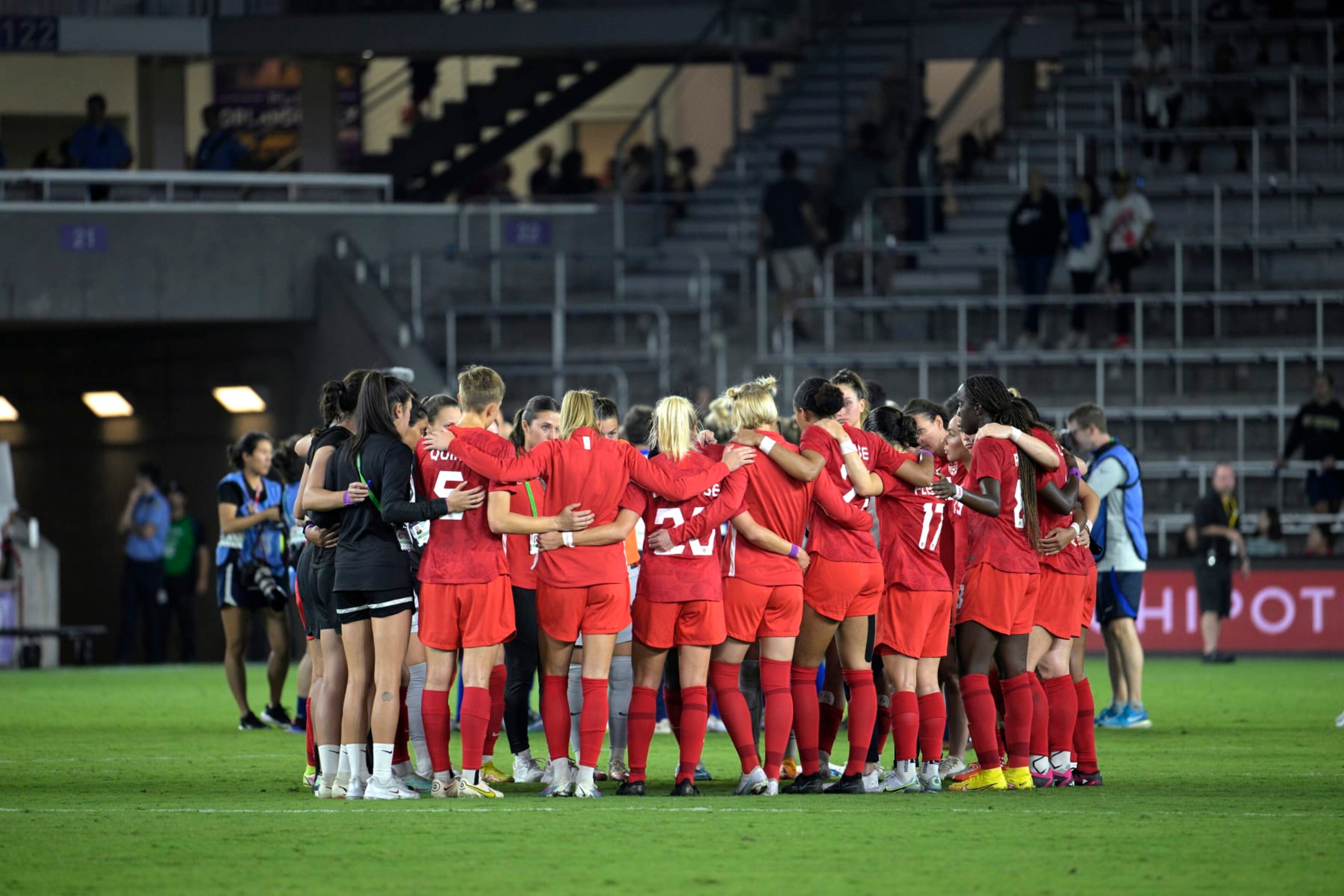 Canada players huddle on the pitch after a SheBelieves Cup women's soccer match against the United States, Thursday, Feb. 16, 2023, in Orlando, Fla. (AP Photo/Phelan M. Ebenhack)