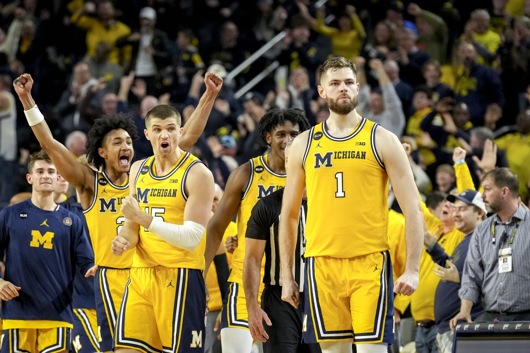 ANN ARBOR, MICHIGAN - FEBRUARY 26: Kobe Bufkin #2 and Joey Baker #15 of the Michigan Wolverines react after Hunter Dickinson #1 of the Michigan Wolverines made a shot that forced the game into overtime against the Wisconsin Badgers during the second half at Crisler Arena on February 26, 2023 in Ann Arbor, Michigan. (Photo by Nic Antaya/Getty Images)