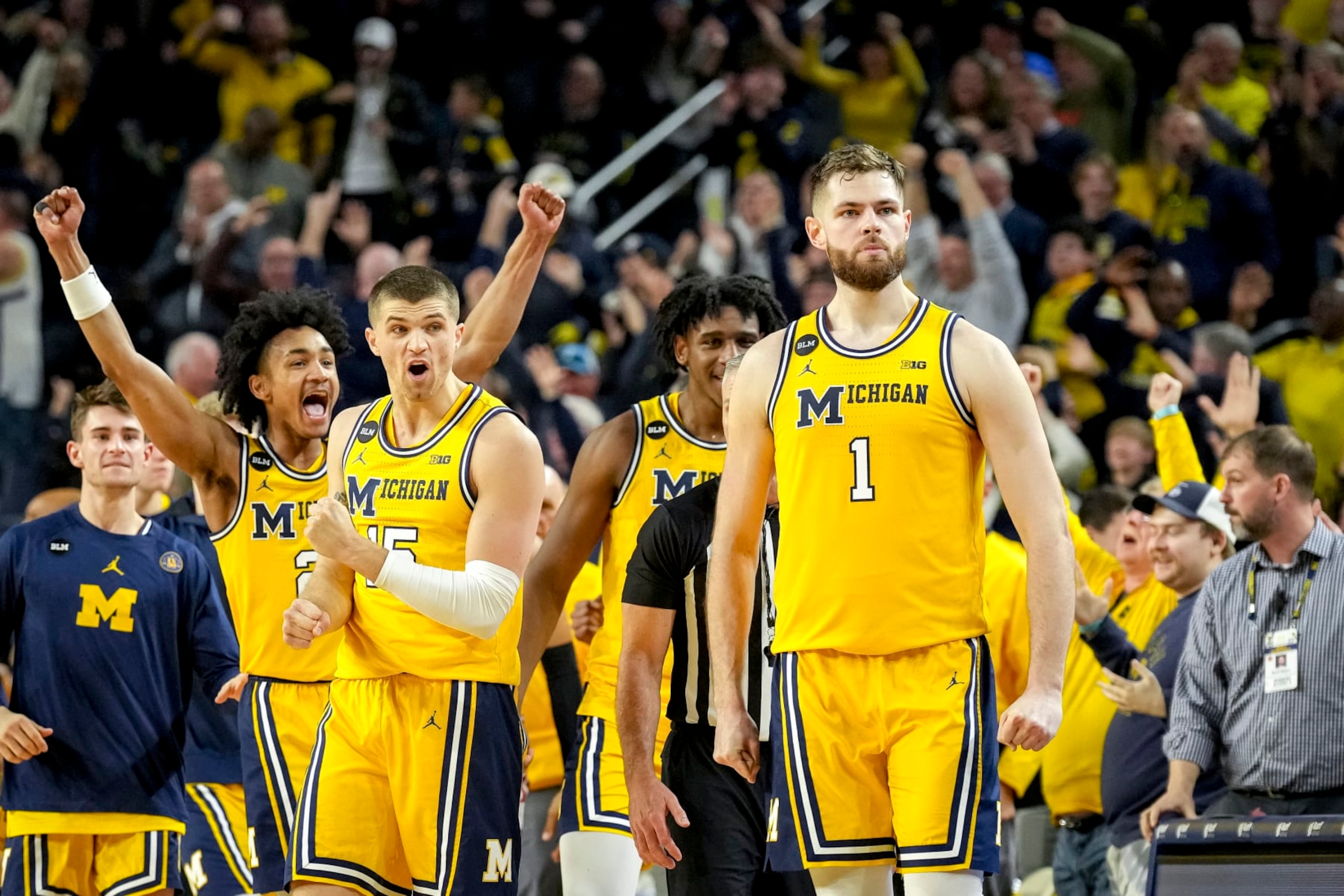 ANN ARBOR, MICHIGAN - FEBRUARY 26: Kobe Bufkin #2 and Joey Baker #15 of the Michigan Wolverines react after Hunter Dickinson #1 of the Michigan Wolverines made a shot that forced the game into overtime against the Wisconsin Badgers during the second half at Crisler Arena on February 26, 2023 in Ann Arbor, Michigan. (Photo by Nic Antaya/Getty Images)