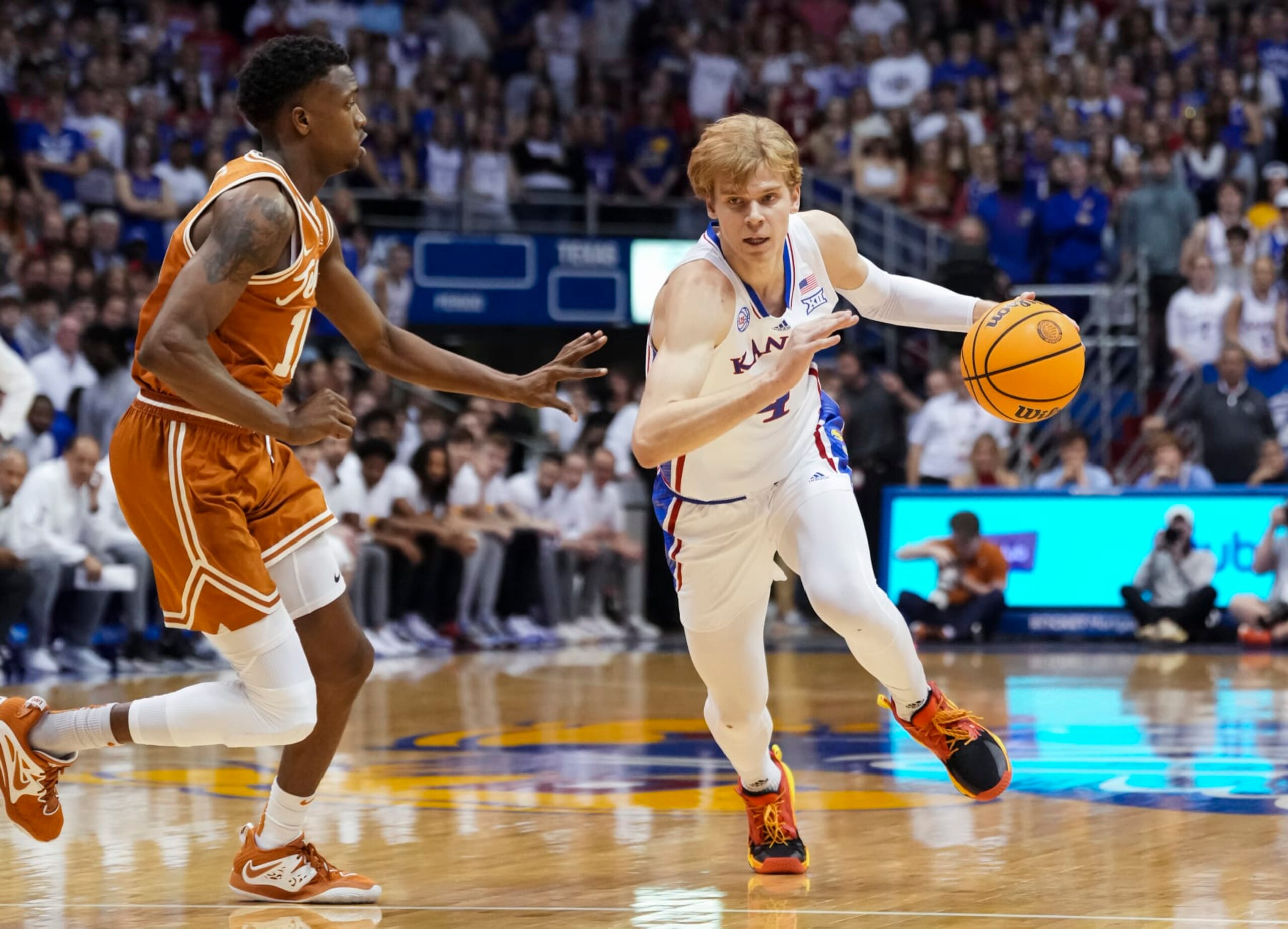 ]LAWRENCE, KS - FEBRUARY 06: Gradey Dick #4 of the Kansas Jayhawks drives against SirJabari Rice #10 of the Texas Longhorns during the first half at Allen Fieldhouse on February 6, 2023 in Lawrence, Kansas. (Photo by Jay Biggerstaff/Getty Images)