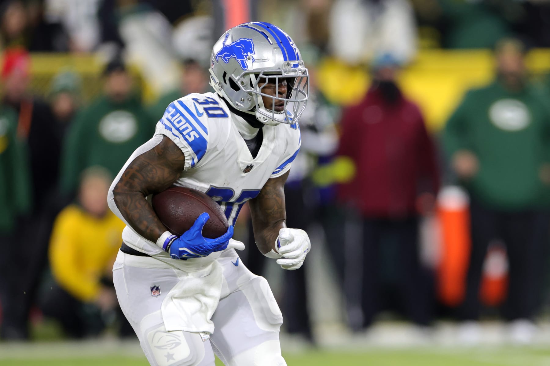 GREEN BAY, WISCONSIN - JANUARY 08: Jamaal Williams #30 of the Detroit Lions rushes during the first quarter against the Green Bay Packers at Lambeau Field on January 08, 2023 in Green Bay, Wisconsin. (Photo by Stacy Revere/Getty Images)