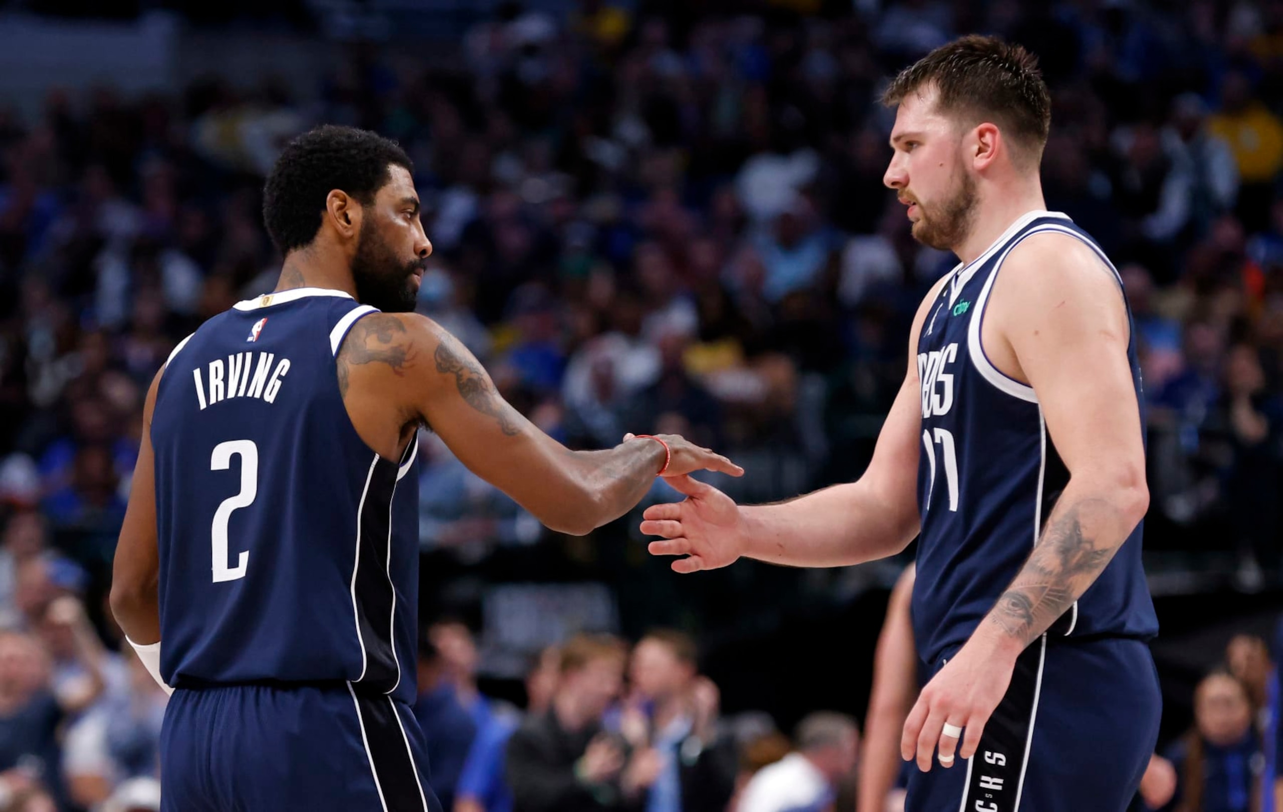 DALLAS, TX - FEBRUARY 26 : Kyrie Irving #2 and teammate Luka Doncic #77 of the Dallas Mavericks shake hands during a game against the Los Angeles Lakers at American Airlines Center on February 26, 2023 in Dallas, Texas. NOTE TO USER: User expressly acknowledges and agrees that, by downloading and or using this photograph, User is consenting to the terms and conditions of the Getty Images License Agreement. (Photo by Ron Jenkins/Getty Images) DALLAS, TX - FEBRUARY 26 : Kyrie Irving #2 and teammate Luka Doncic #77 of the Dallas Mavericks shake hands during a game against the Los Angeles Lakers at American Airlines Center on February 26, 2023 in Dallas, Texas. NOTE TO USER: User expressly acknowledges and agrees that, by downloading and or using this photograph, User is consenting to the terms and conditions of the Getty Images License Agreement. (Photo by Ron Jenkins/Getty Images)