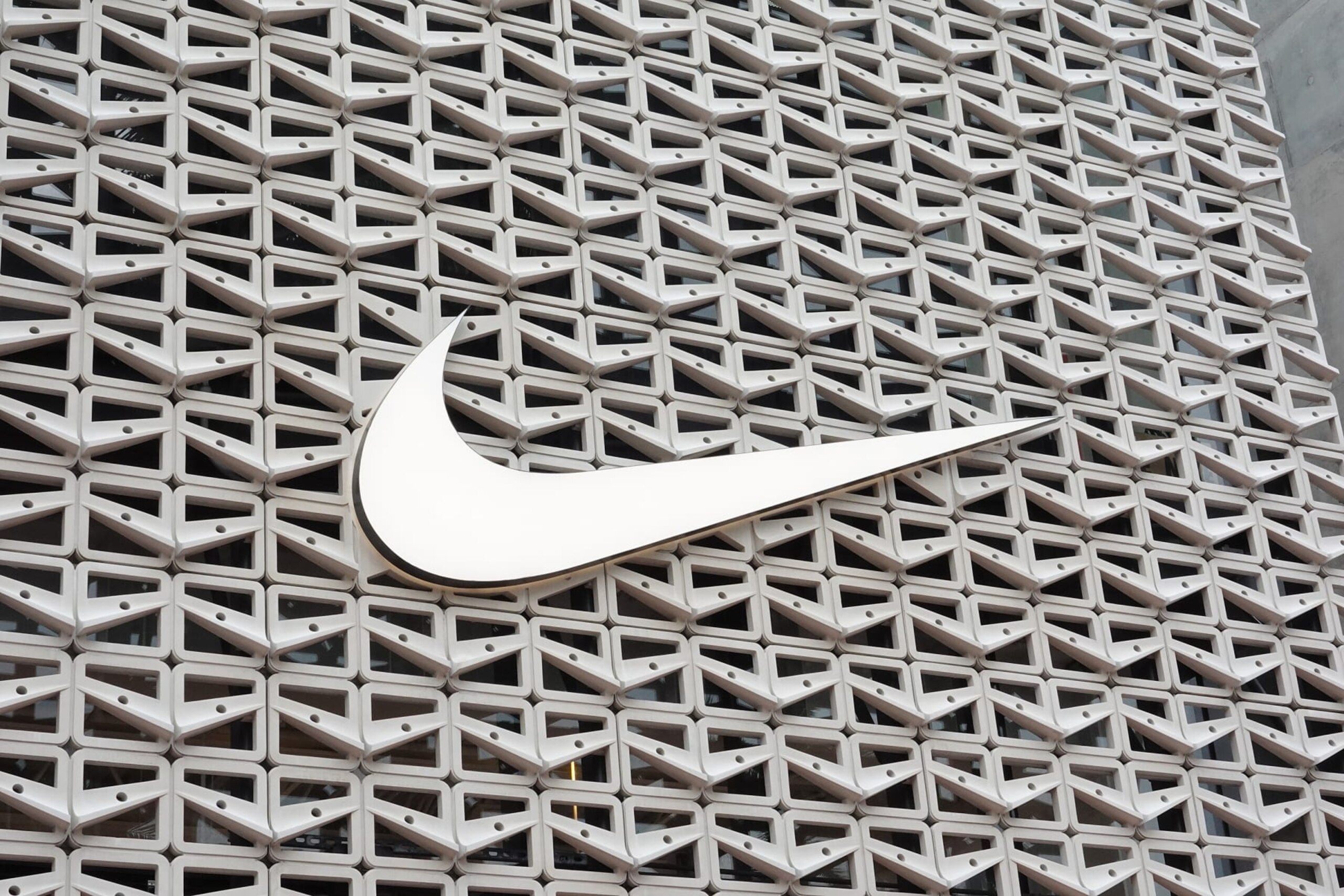 MIAMI BEACH, FLORIDA - DECEMBER 21: The Nike logo hangs above the entrance to the Nike store on December 21, 2021 in Miami Beach, Florida. Nike reported better-than-expected fiscal second-quarter results with revenue of $11.36 billion vs. $11.25 billion expected. (Photo by Joe Raedle/Getty Images) MIAMI BEACH, FLORIDA - DECEMBER 21: The Nike logo hangs above the entrance to the Nike store on December 21, 2021 in Miami Beach, Florida. Nike reported better-than-expected fiscal second-quarter results with revenue of $11.36 billion vs. $11.25 billion expected. (Photo by Joe Raedle/Getty Images)