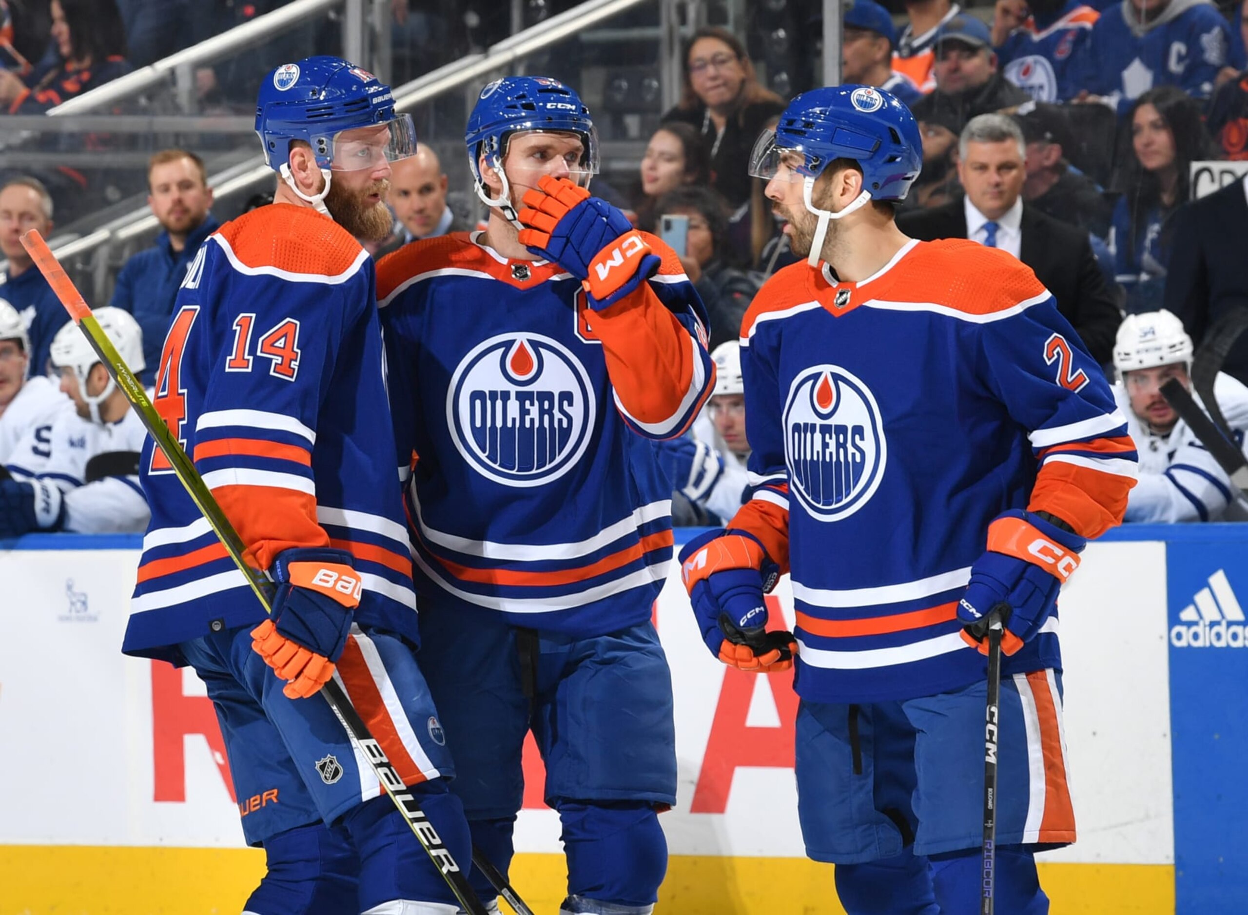 EDMONTON, CANADA - MARCH 1: Connor McDavid #97, Mattias Ekholm #14 and Evan Bouchard #2 of the Edmonton Oilers have a conversation during a stoppage in play during the game against the Toronto Maple Leafs on March 1, 2023 at Rogers Place in Edmonton, Alberta, Canada. (Photo by Andy Devlin/NHLI via Getty Images)