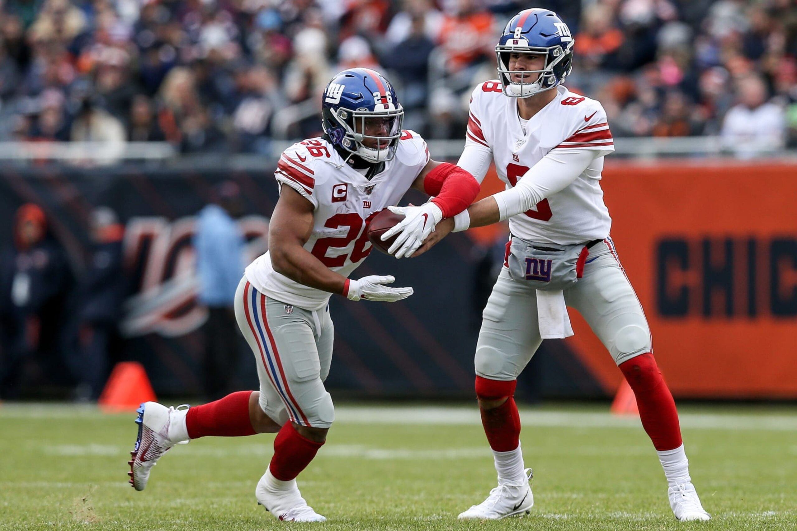 CHICAGO, ILLINOIS - NOVEMBER 24: Daniel Jones #8 of the New York Giants hands the ball off to Saquon Barkley #26 in the second quarter against the Chicago Bears at Soldier Field on November 24, 2019 in Chicago, Illinois. (Photo by Dylan Buell/Getty Images)