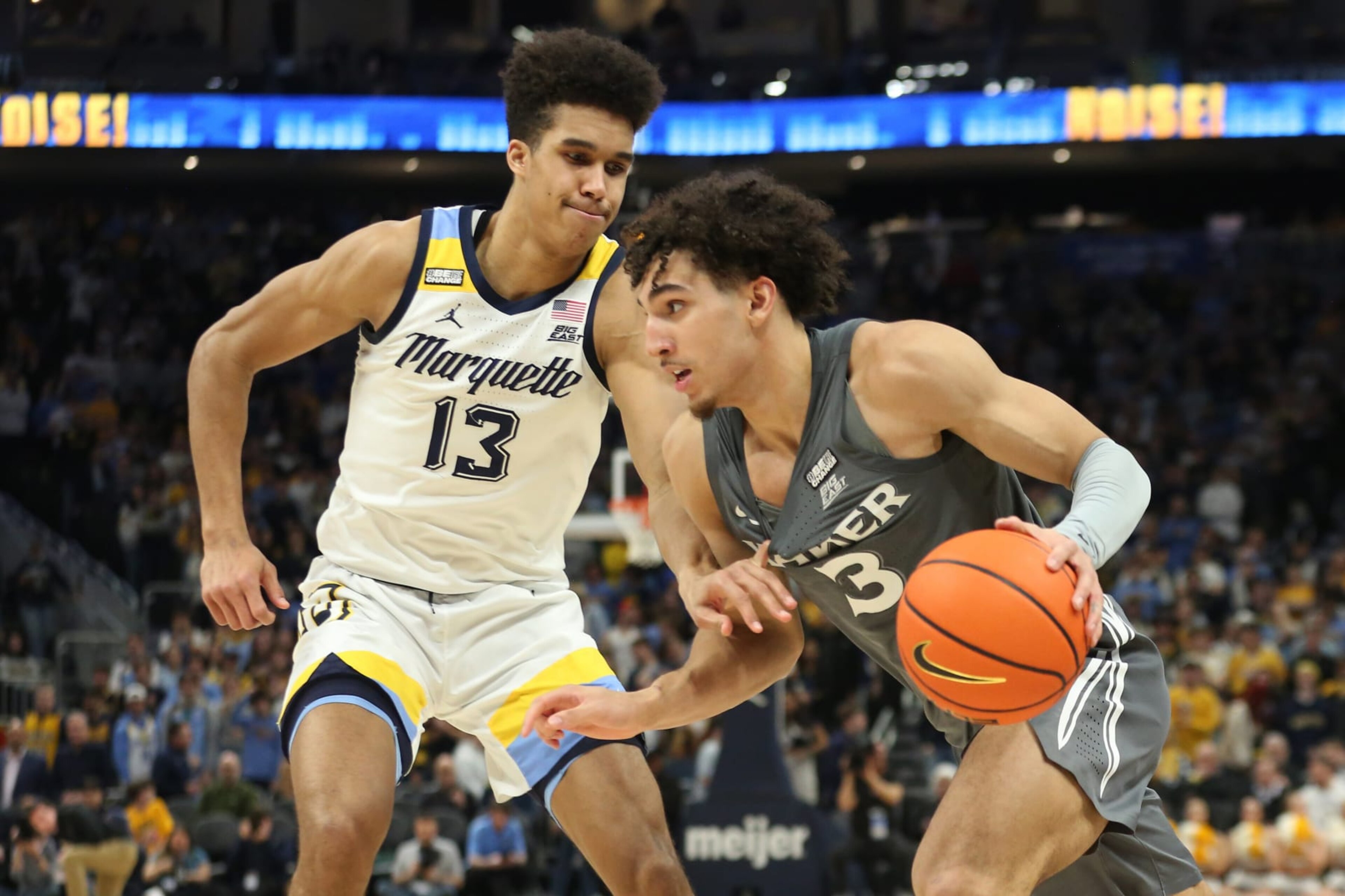 Marquette's Oso Ighodaro defends Xavier's Colby Jones.