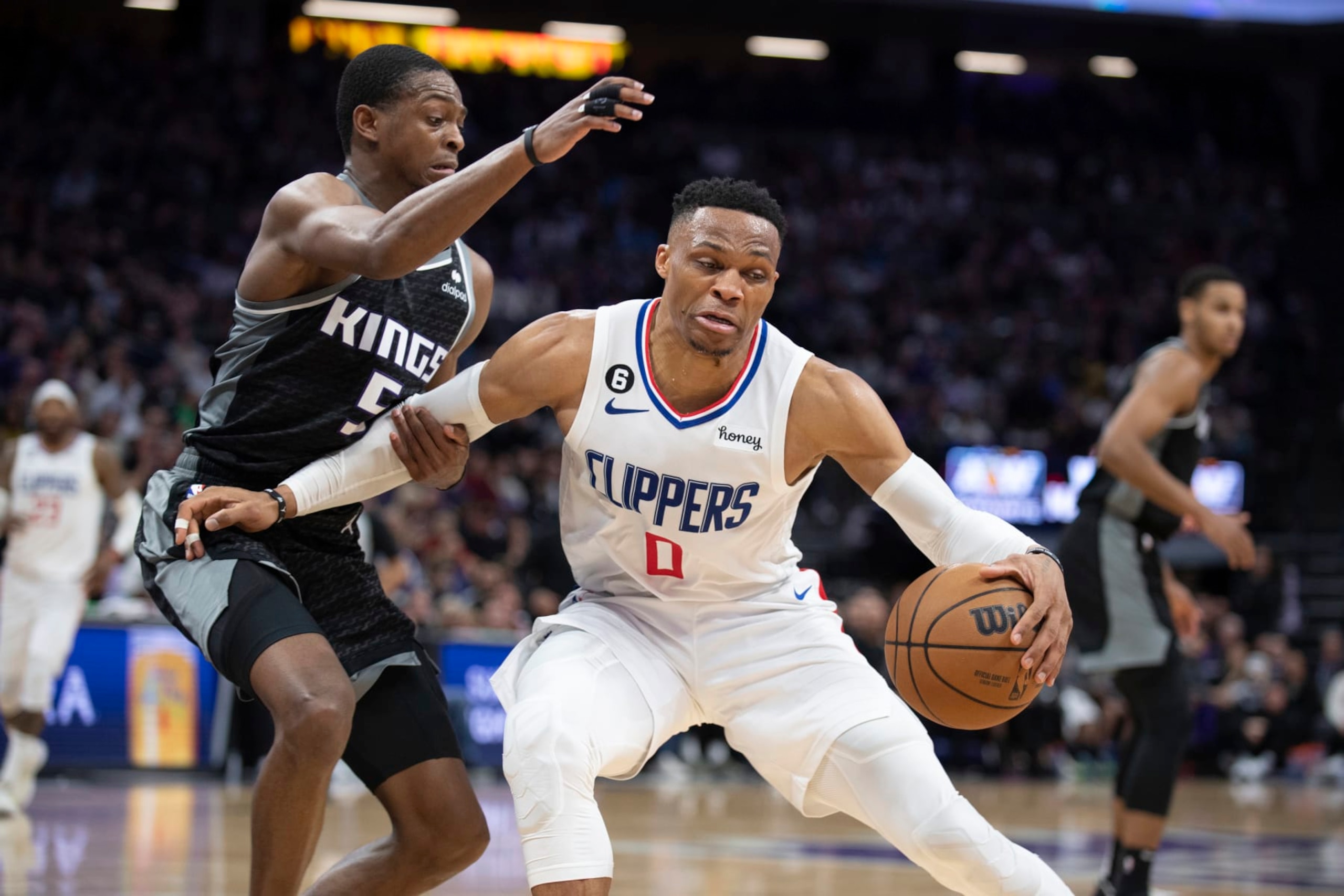 Los Angeles Clippers guard Russell Westbrook (0) is defended by Sacramento Kings guard De'Aaron Fox (5) during the second half in an NBA basketball game in Sacramento, Calif., Friday, March 3, 2023. The Kings won 128-127. (AP Photo/José Luis Villegas)