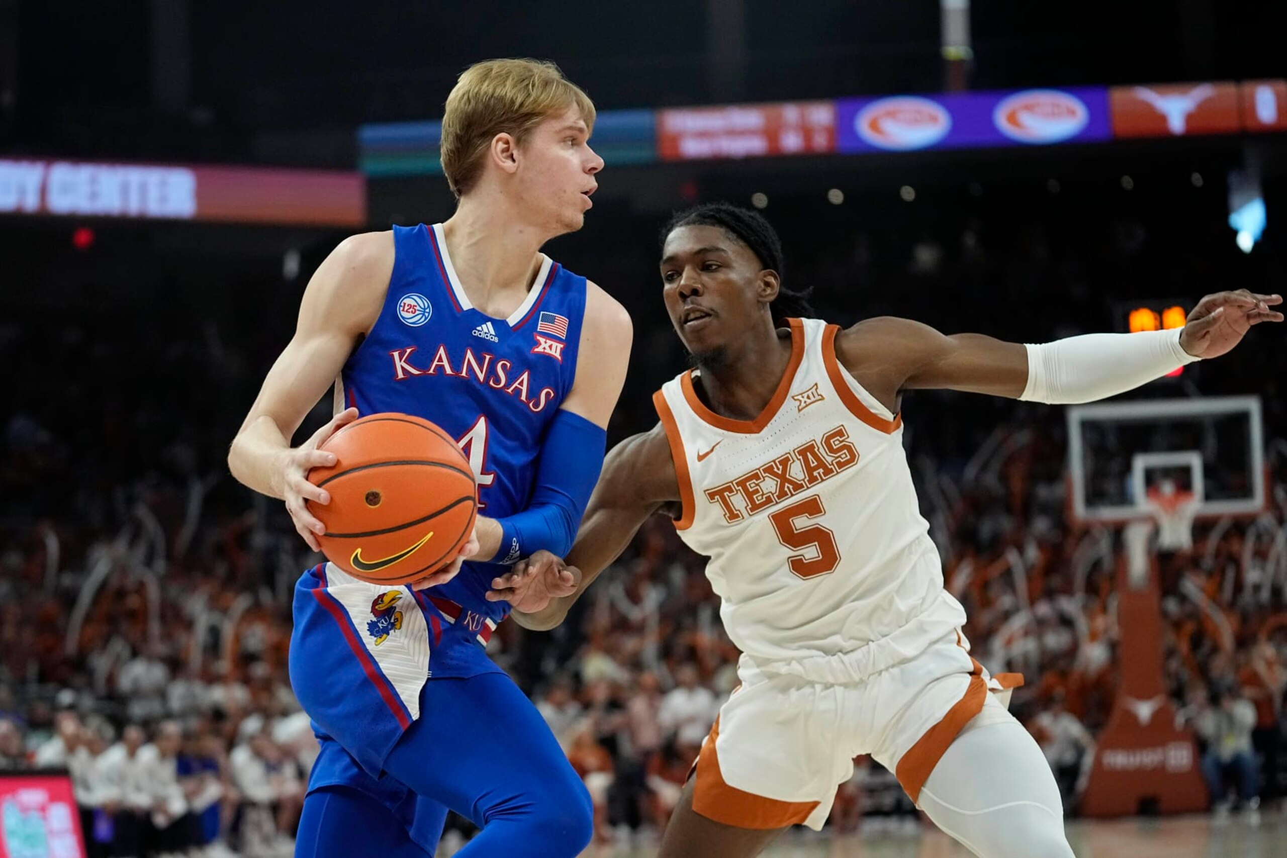 Kansas guard Gradey Dick (4) drives around Texas guard Marcus Carr (5)during the first half of an NCAA college basketball game in Austin, Texas, Saturday, March 4, 2023. (AP Photo/Eric Gay)