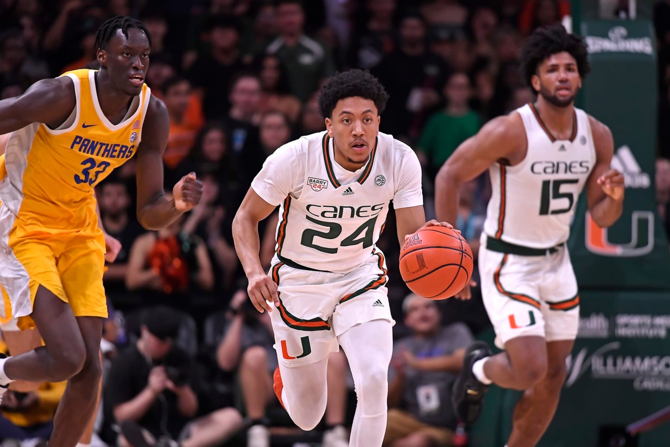 CORAL GABLES, FL - MAR 04: Miami guard Nijel Pack (24) drives to the basket after recovering a loose ball in the first half followed by Pittsburgh center Federiko Federiko (33) as the Miami Hurricanes faced the Pittsburgh Panthers on March 4, 2023, at the Watsco Center in Coral Gables, Florida. (Photo by Samuel Lewis/Icon Sportswire via Getty Images)