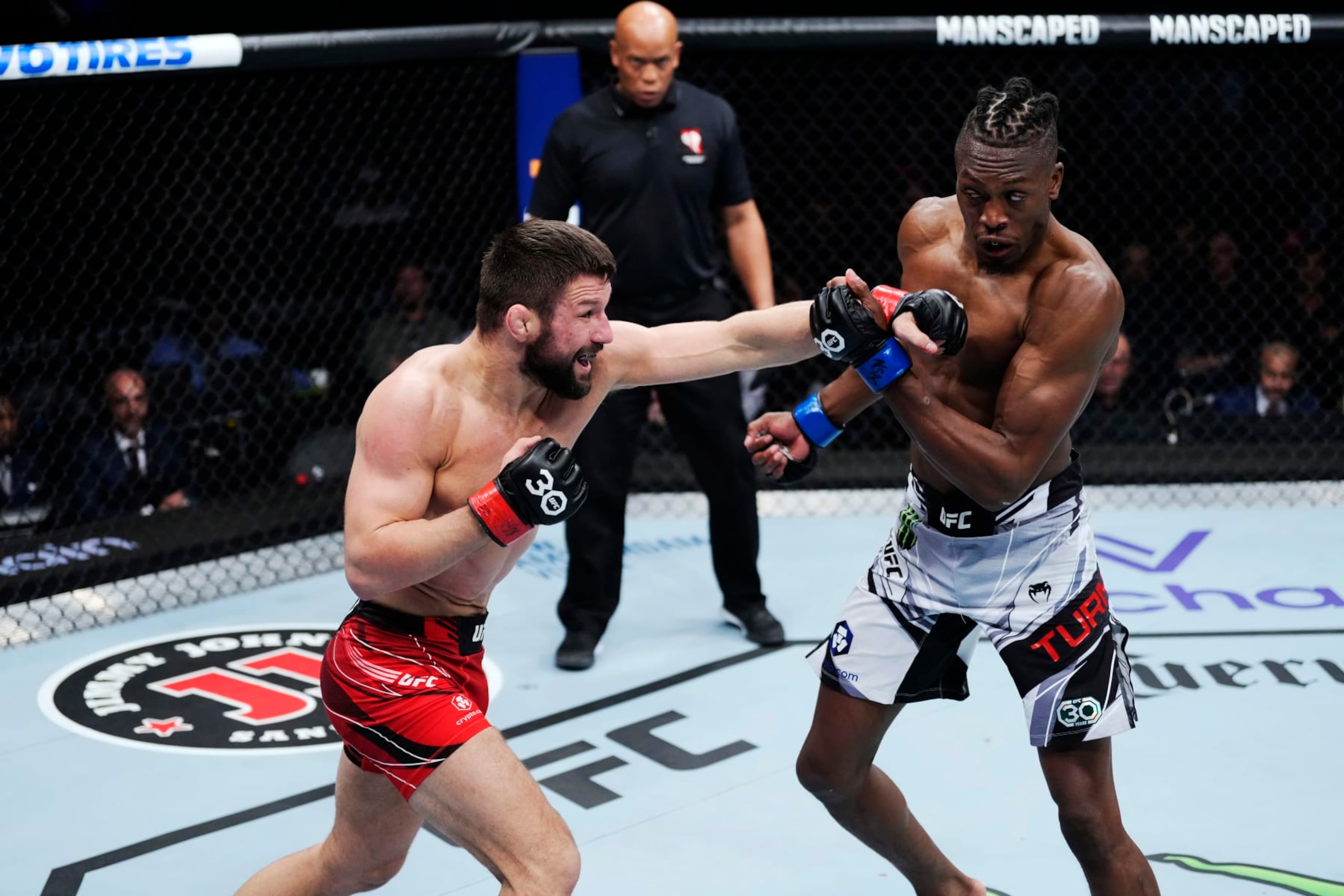 LAS VEGAS, NEVADA - MARCH 04: (L-R) Mateusz Gamrot of Poland punches Jalin Turner in a lightweight fight during the UFC 285 event at T-Mobile Arena on March 04, 2023 in Las Vegas, Nevada. (Photo by Jeff Bottari/Zuffa LLC via Getty Images)