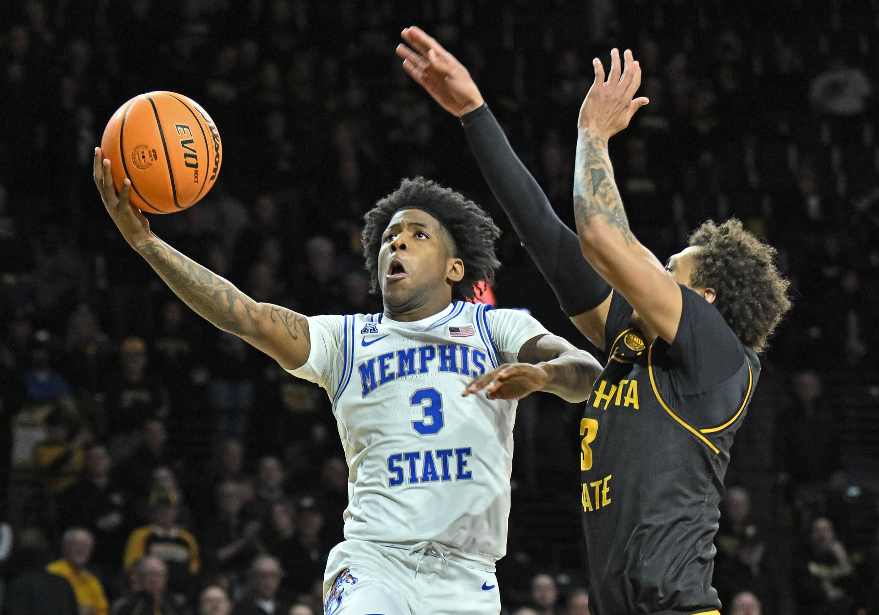 WICHITA, KS - FEBRUARY 23:  Kendric Davis #3 of the Memphis Tigers drives to the basket against Craig Porter Jr. #3 of the Wichita State Shockers in the second half at Charles Koch Arena on February 23, 2023 in Wichita, Kansas.  (Photo by Peter Aiken/Getty Images)