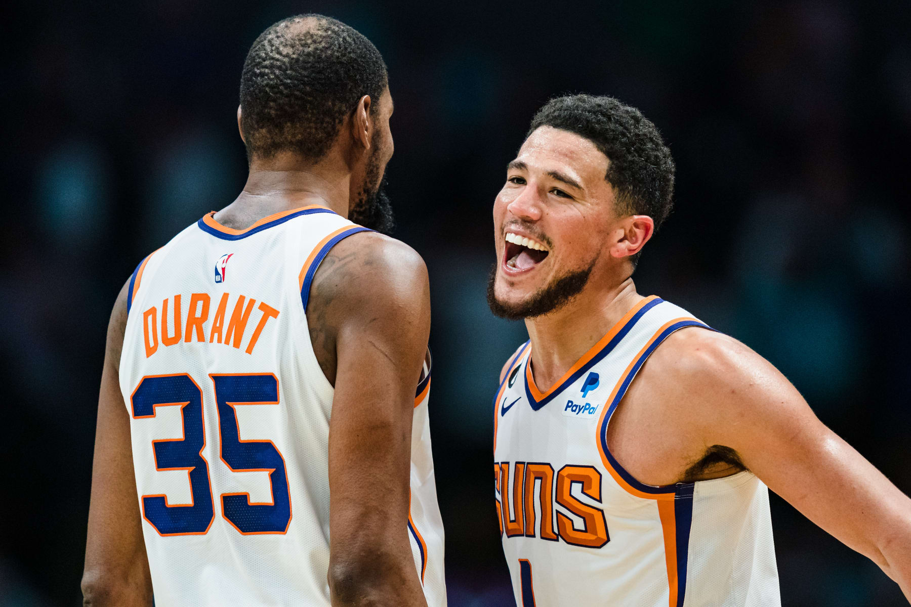 CHARLOTTE, NORTH CAROLINA - MARCH 01: Kevin Durant #35 celebrates with Devin Booker #1 of the Phoenix Suns in the fourth quarter during their game against the Charlotte Hornets at Spectrum Center on March 01, 2023 in Charlotte, North Carolina. NOTE TO USER: User expressly acknowledges and agrees that, by downloading and or using this photograph, User is consenting to the terms and conditions of the Getty Images License Agreement. (Photo by Jacob Kupferman/Getty Images)