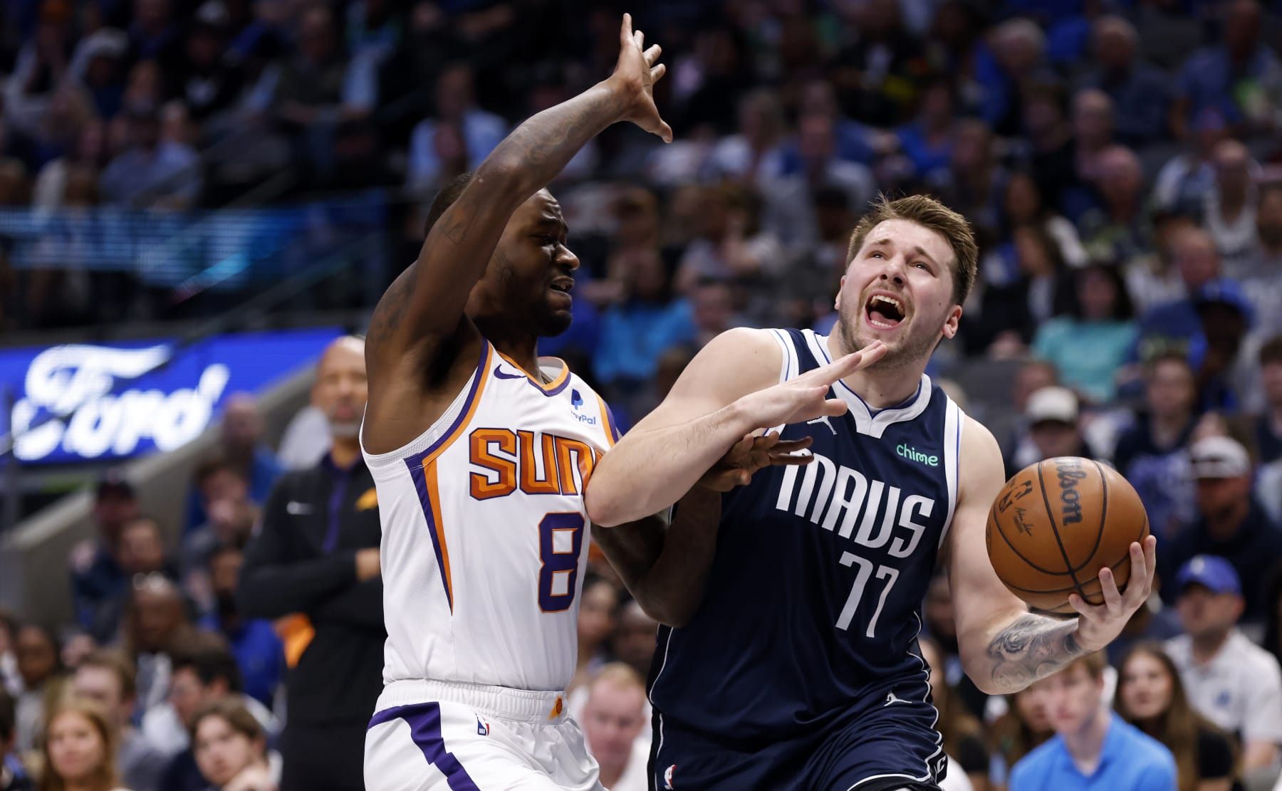 DALLAS, TX - MARCH 5: Luka Doncic #77 of the Dallas Mavericks goes to the basket as Terrence Ross #8 of the Phoenix Suns defends in the first half of the game at American Airlines Center on March 5, 2023 in Dallas, Texas. NOTE TO USER: User expressly acknowledges and agrees that, by downloading and or using this photograph, User is consenting to the terms and conditions of the Getty Images License Agreement. (Photo by Ron Jenkins/Getty Images)