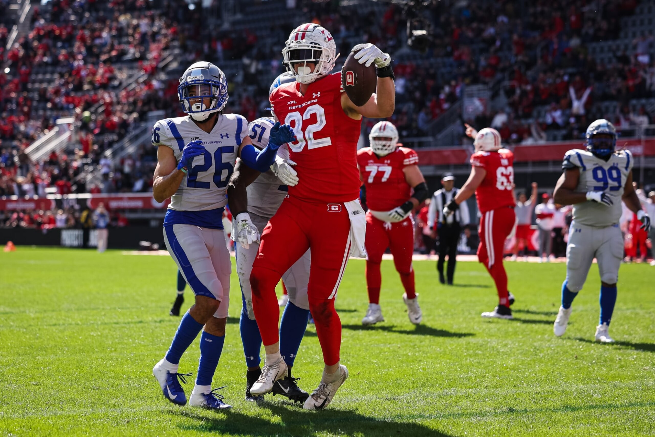 WASHINGTON, DC - MARCH 05: Ethan Wolf #82 of the DC Defenders scores a touchdown in front of Nate Meadors #26 of the St Louis Battlehawks during the first half of the XFL game at Audi Field on March 5, 2023 in Washington, DC. (Photo by Scott Taetsch/Getty Images)