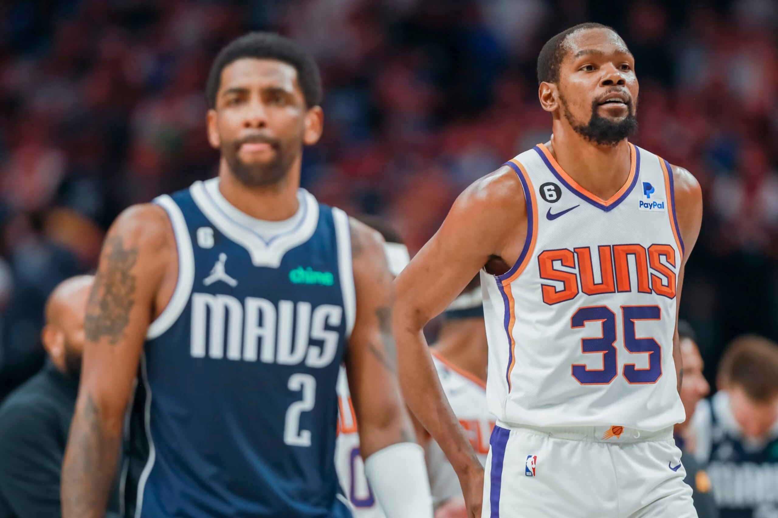 Dallas Mavericks guard Kyrie Irving (2) and Phoenix Suns forward Kevin Durant (35) walk down the court during the second half of an NBA basketball game, Sunday, March 5, 2023, in Dallas. (AP Photo/Gareth Patterson)