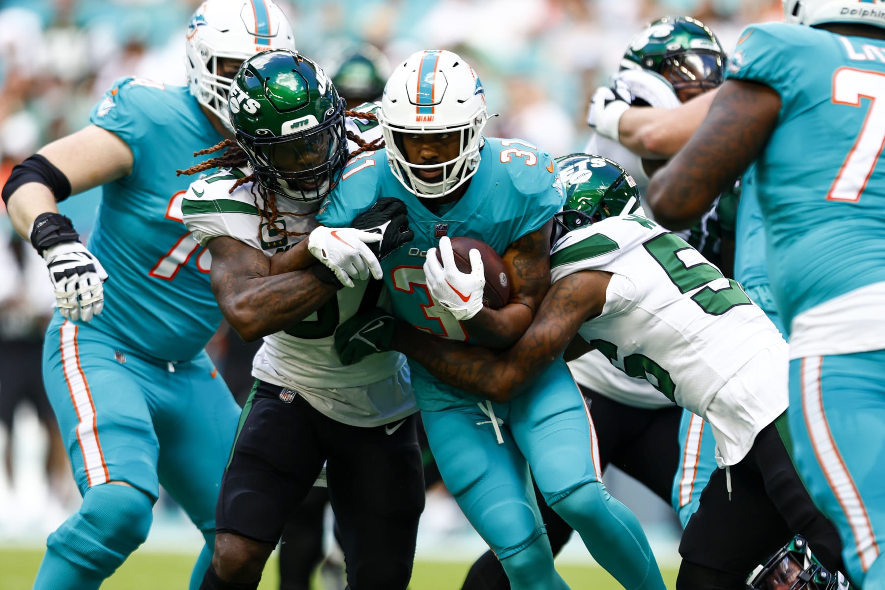 MIAMI GARDENS, FL - JANUARY 8: Raheem Mostert #31 of the Miami Dolphins carries the ball during the first quarter of an NFL football game against the New York Jets at Hard Rock Stadium on January 8, 2023 in Miami Gardens, Florida. (Photo by Kevin Sabitus/Getty Images)