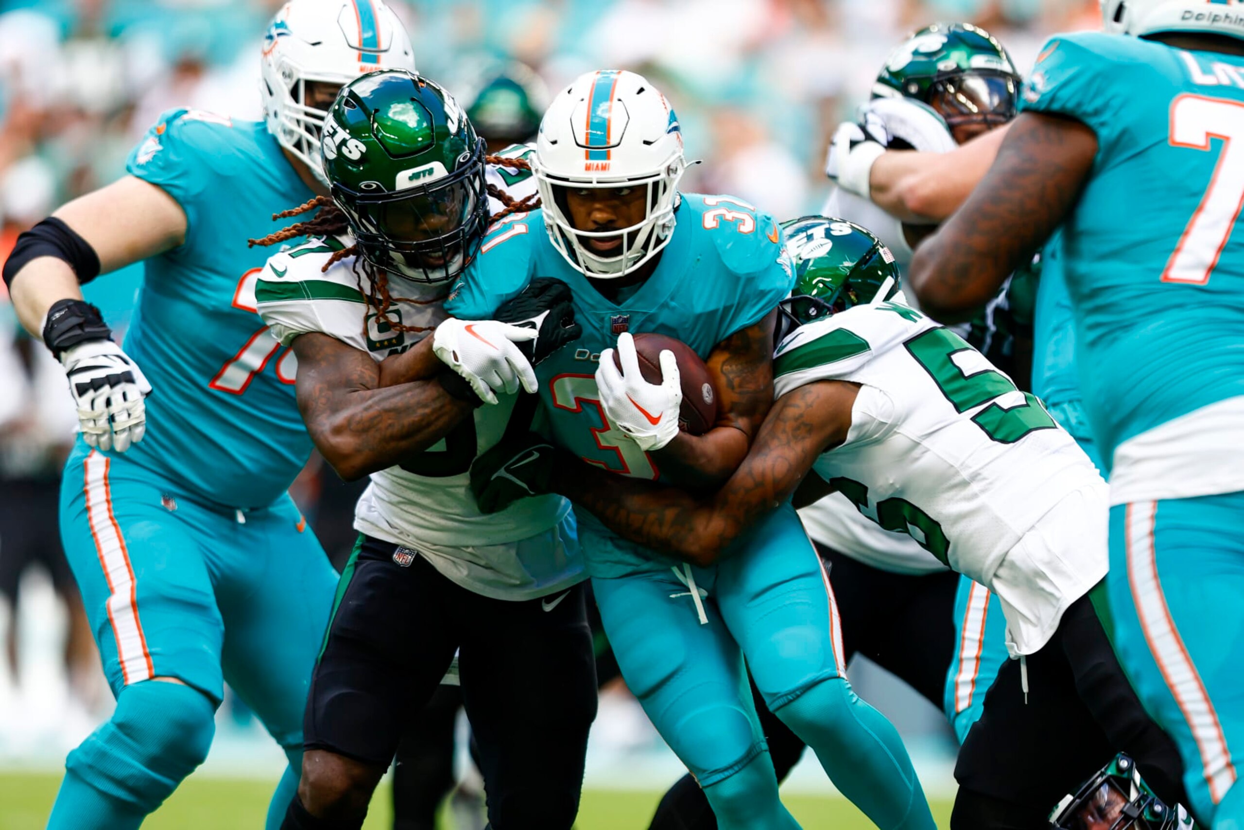 MIAMI GARDENS, FL - JANUARY 8: Raheem Mostert #31 of the Miami Dolphins carries the ball during the first quarter of an NFL football game against the New York Jets at Hard Rock Stadium on January 8, 2023 in Miami Gardens, Florida. (Photo by Kevin Sabitus/Getty Images)