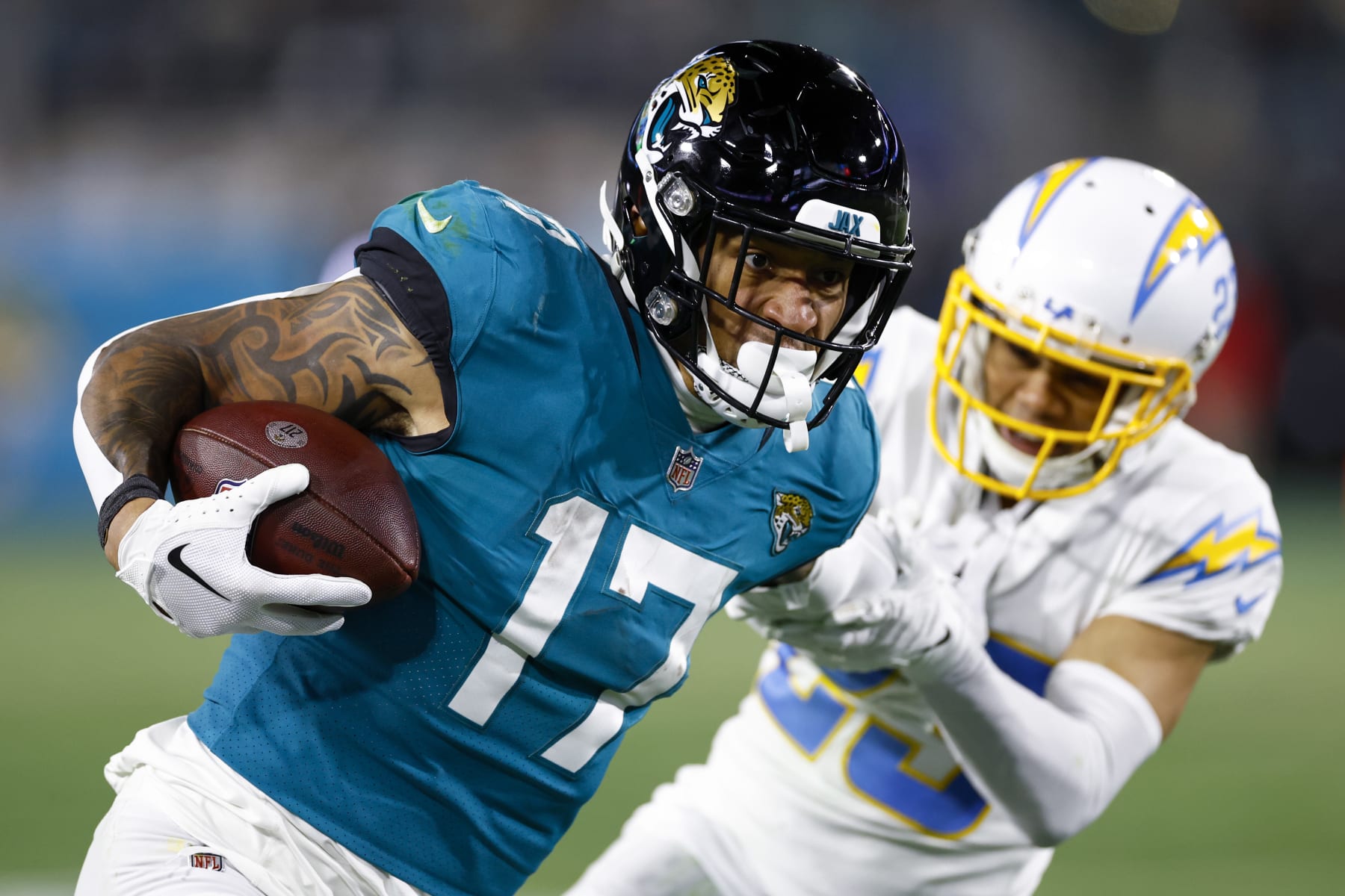 JACKSONVILLE, FLORIDA - JANUARY 14: Evan Engram #17 of the Jacksonville Jaguars carries the ball against the Los Angeles Chargers during the second half of the game in the AFC Wild Card playoff game at TIAA Bank Field on January 14, 2023 in Jacksonville, Florida. (Photo by Douglas P. DeFelice/Getty Images)