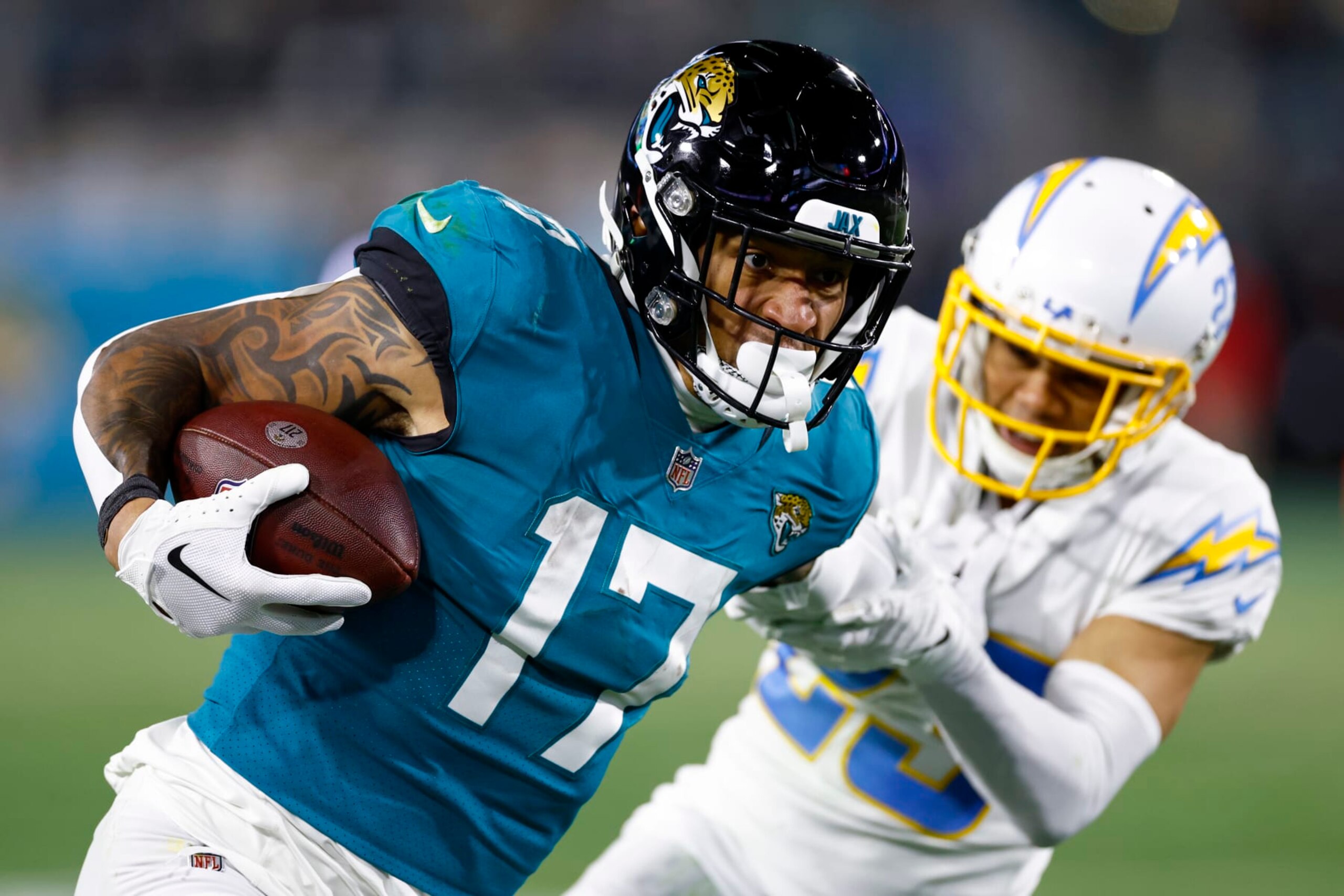 JACKSONVILLE, FLORIDA - JANUARY 14: Evan Engram #17 of the Jacksonville Jaguars carries the ball against the Los Angeles Chargers during the second half of the game in the AFC Wild Card playoff game at TIAA Bank Field on January 14, 2023 in Jacksonville, Florida. (Photo by Douglas P. DeFelice/Getty Images)