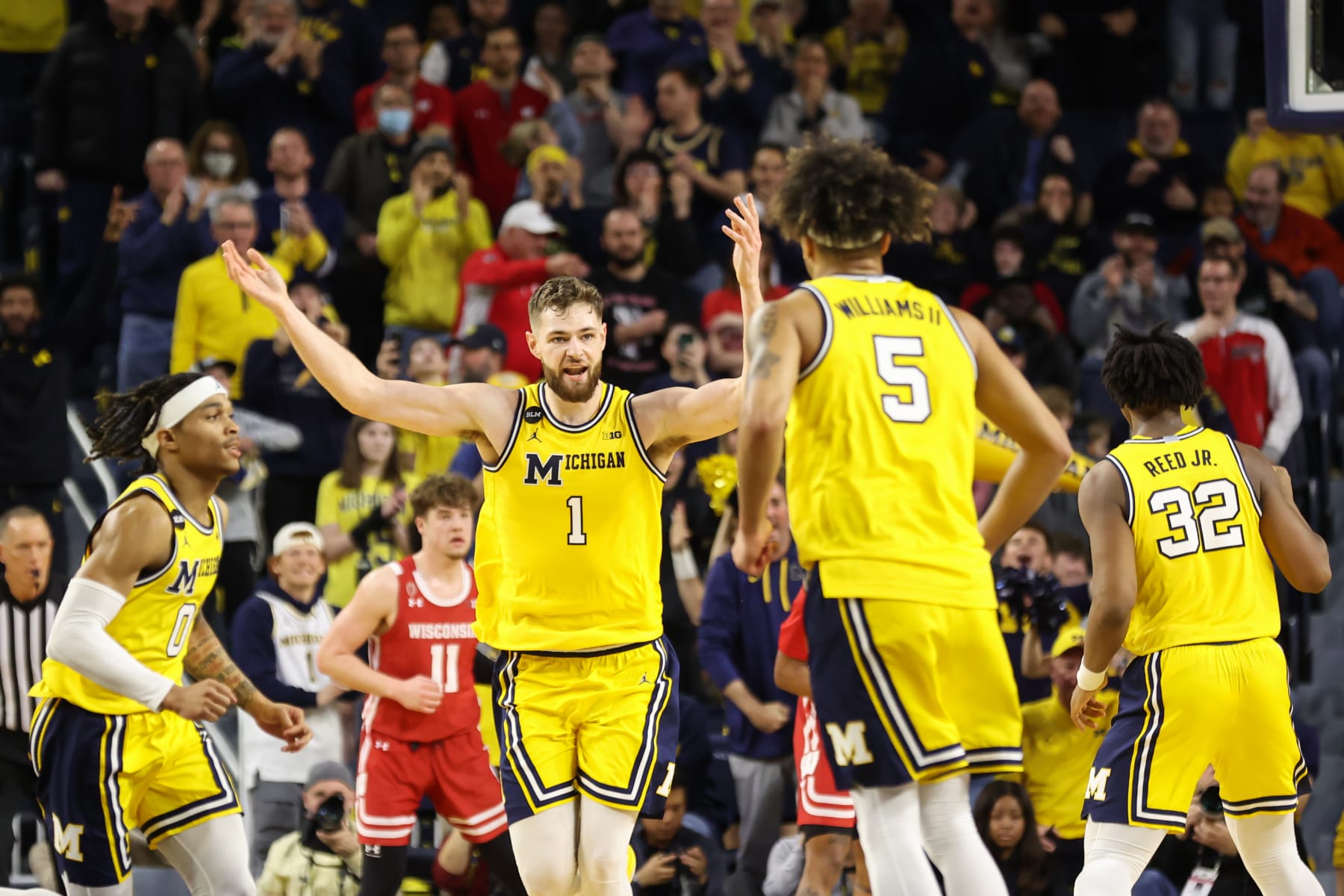 ANN ARBOR, MI - FEBRUARY 26:  Michigan Wolverines center Hunter Dickinson (1) waves his arms to pump up the fans after scoring a basket during overtime of a Big Ten Conference regular season college basketball game between the Wisconsin Badgers and the Michigan Wolverines on February 26, 2023 at the Crisler Center in Ann Arbor, Michigan.  (Photo by Scott W. Grau/Icon Sportswire via Getty Images)