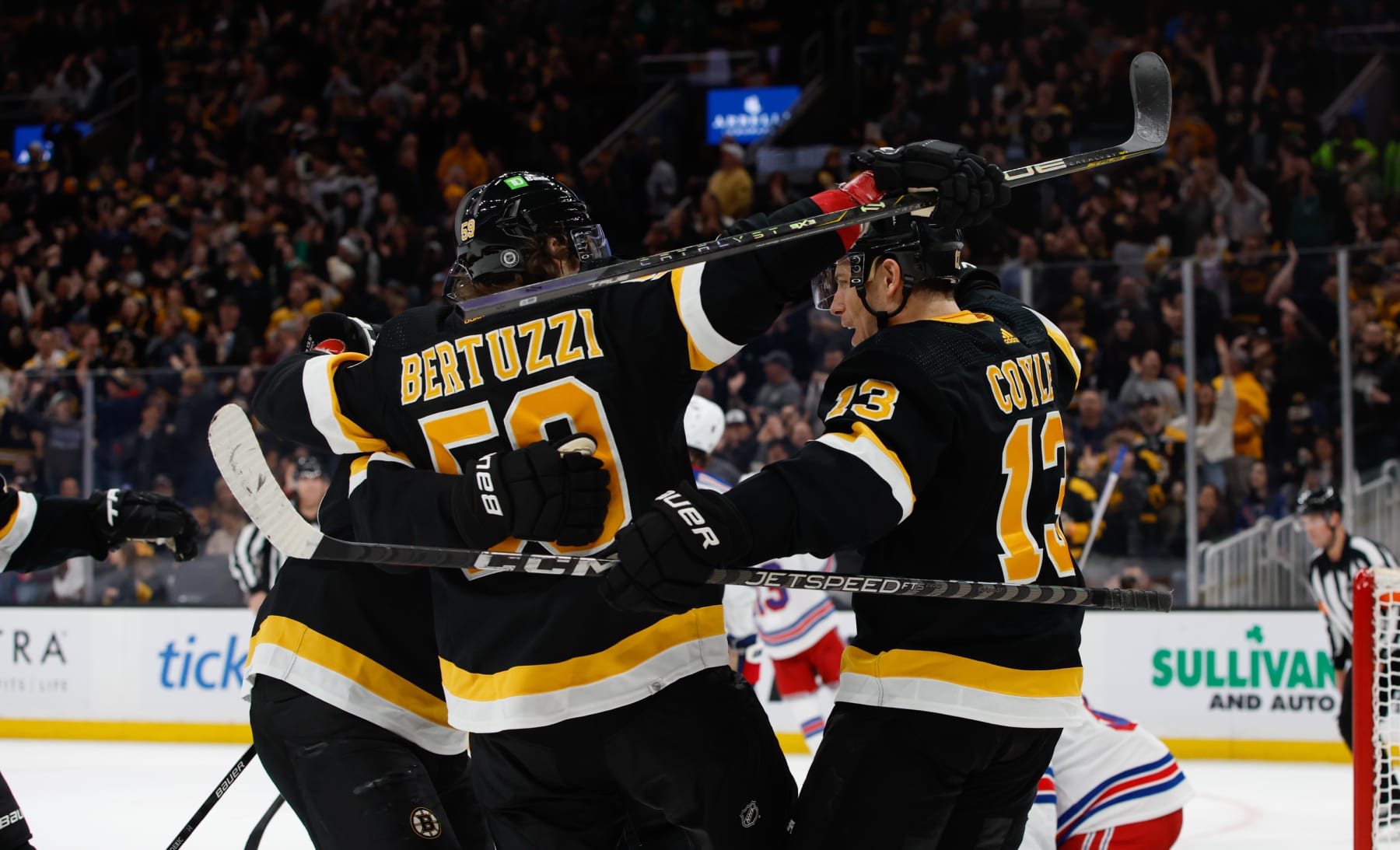 BOSTON, MA - MARCH 4: Charlie Coyle #13 of the Boston Bruins celebrates with his teammates Tyler Bertuzzi #59 and Trent Frederic #11 after he scored a goal against the New York Rangers during the first period at the TD Garden on March 4, 2023 in Boston, Massachusetts. (Photo by Richard T Gagnon/Getty Images)
