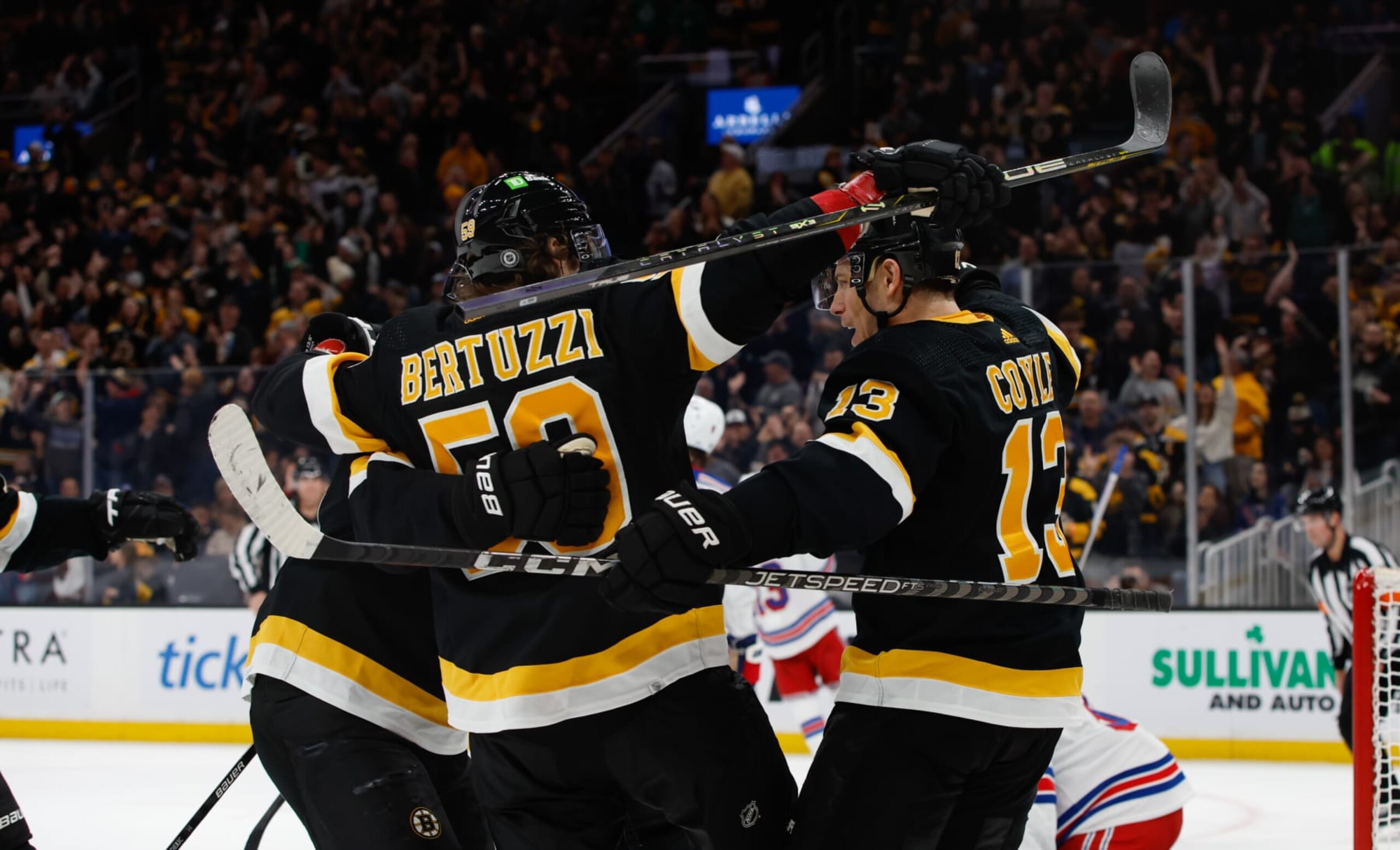 BOSTON, MA - MARCH 4: Charlie Coyle #13 of the Boston Bruins celebrates with his teammates Tyler Bertuzzi #59 and Trent Frederic #11 after he scored a goal against the New York Rangers during the first period at the TD Garden on March 4, 2023 in Boston, Massachusetts. (Photo by Richard T Gagnon/Getty Images)
