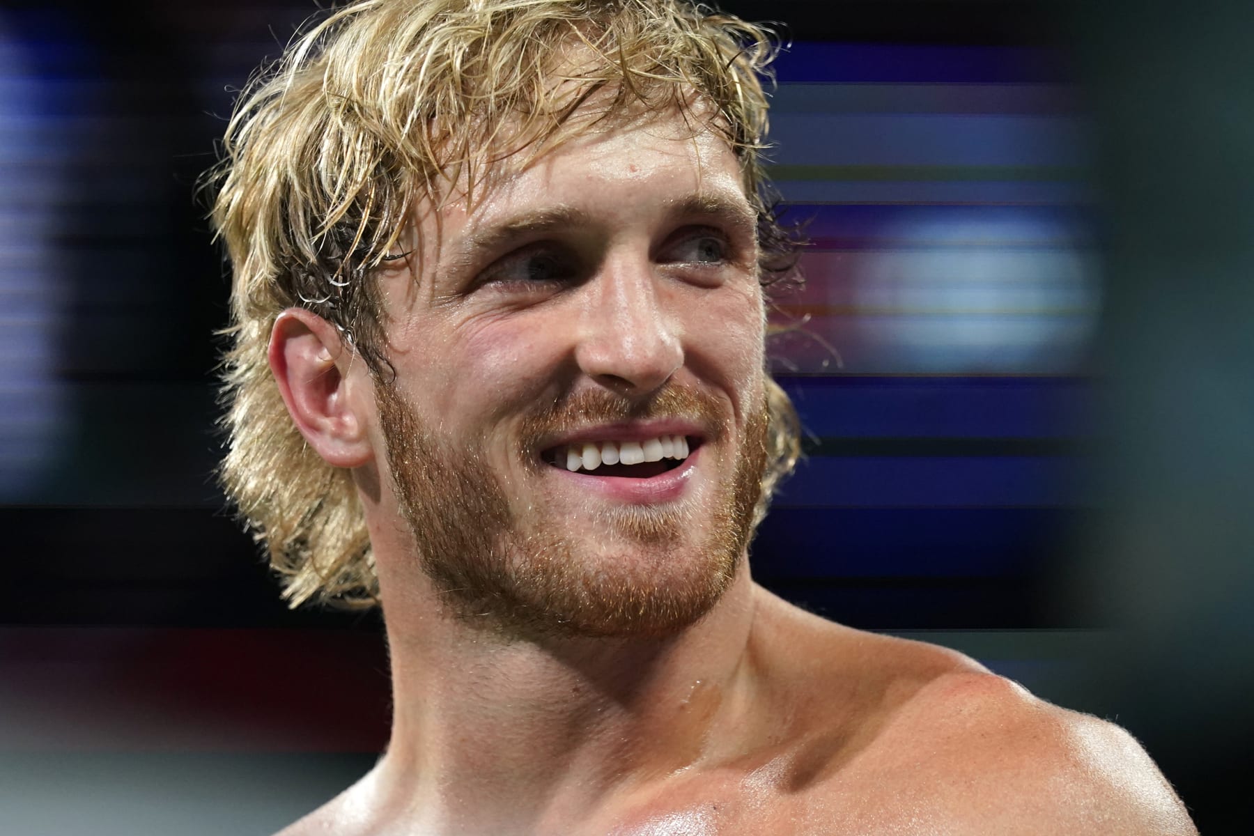 File - Social media personality Logan Paul stands in the ring before an exhibition boxing match, Sunday, June 6, 2021, in Miami Gardens, Fla. Three months after signing a contract with WWE last year, Paul took out a cell phone and filmed himself jumping from the ropes and onto wrestler Roman Reigns. (AP Photo/Lynne Sladky, File)
