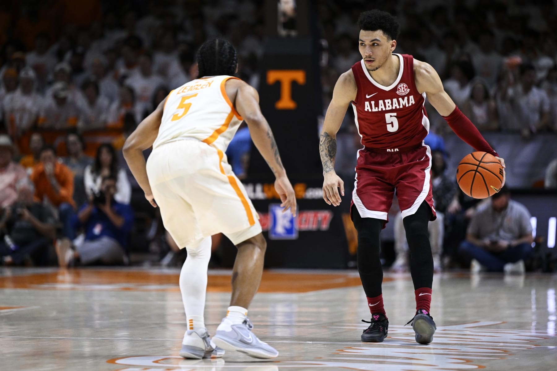 KNOXVILLE, TENNESSEE - FEBRUARY 15: Jahvon Quinerly #5 of the Alabama Crimson Tide dribbles against Zakai Zeigler #5 of the Tennessee Volunteers in the first half at Thompson-Boling Arena on February 15, 2023 in Knoxville, Tennessee. (Photo by Eakin Howard/Getty Images)
