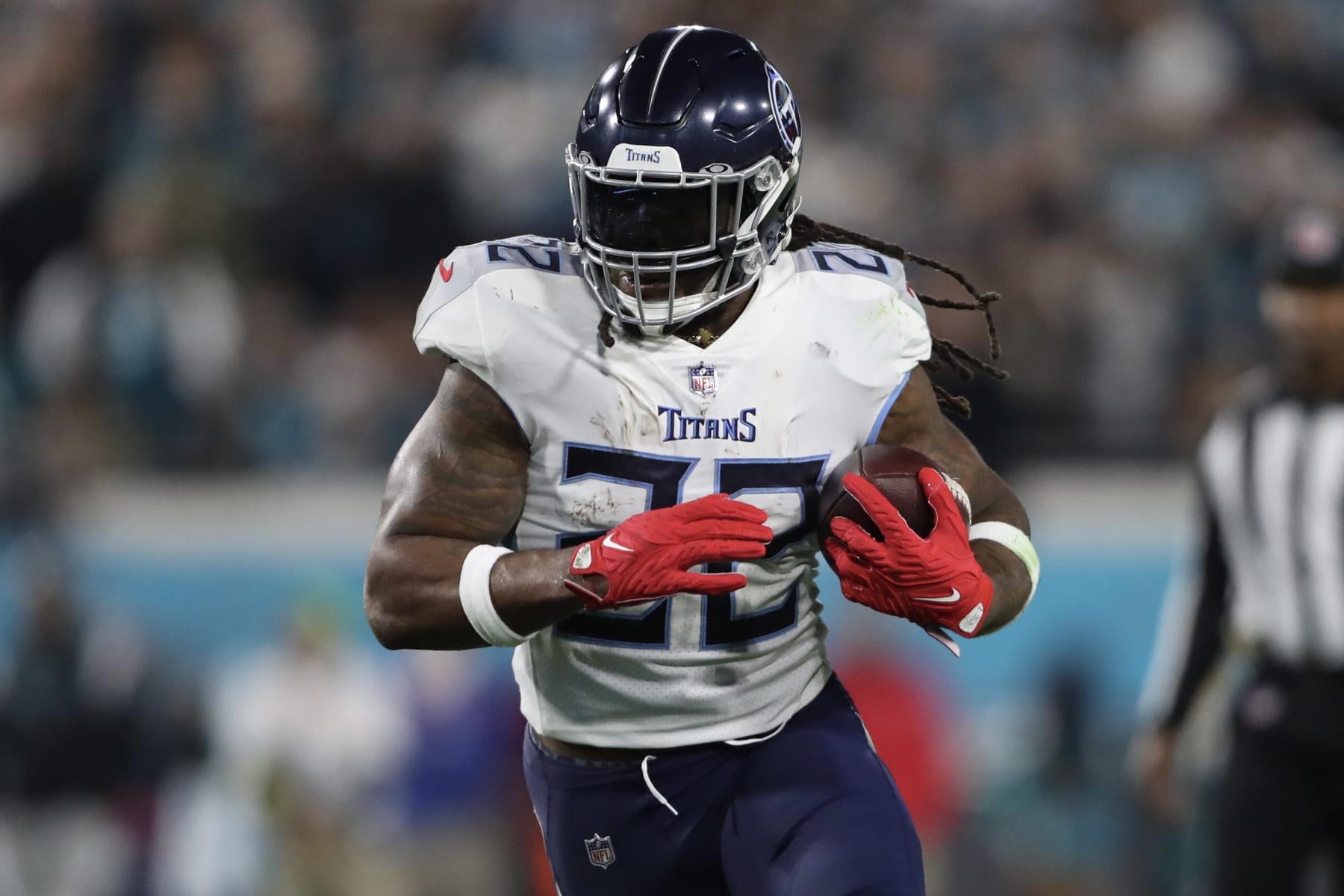 JACKSONVILLE, FLORIDA - JANUARY 07: Derrick Henry #22 of the Tennessee Titans carries the ball during the first half against the Jacksonville Jaguars at TIAA Bank Field on January 07, 2023 in Jacksonville, Florida. (Photo by Courtney Culbreath/Getty Images)