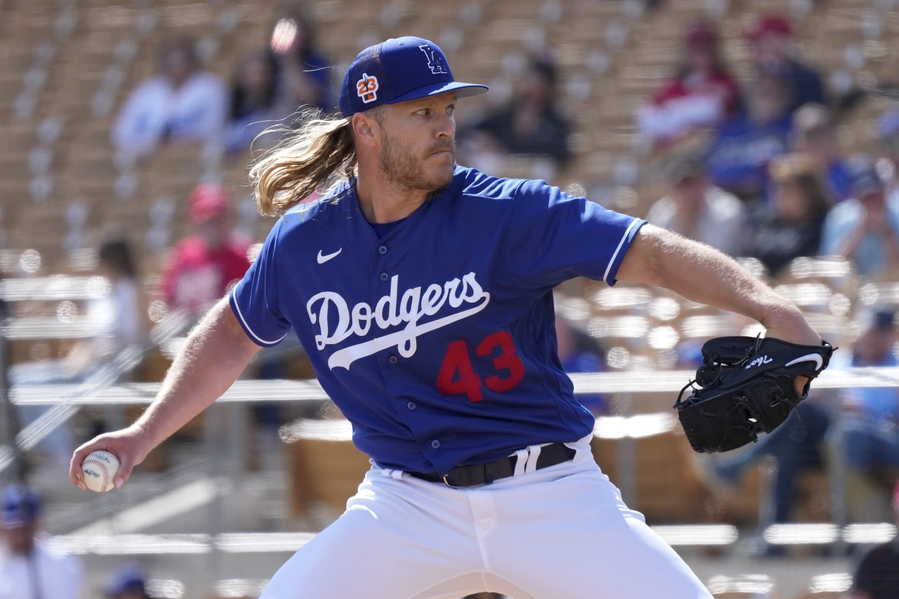 Los Angeles Dodgers pitcher Noah Syndergaard throws a pitch against the Cincinnati Reds during the fourth inning of a spring training baseball game Tuesday, Feb. 28, 2023, in Phoenix. (AP Photo/Ross D. Franklin)