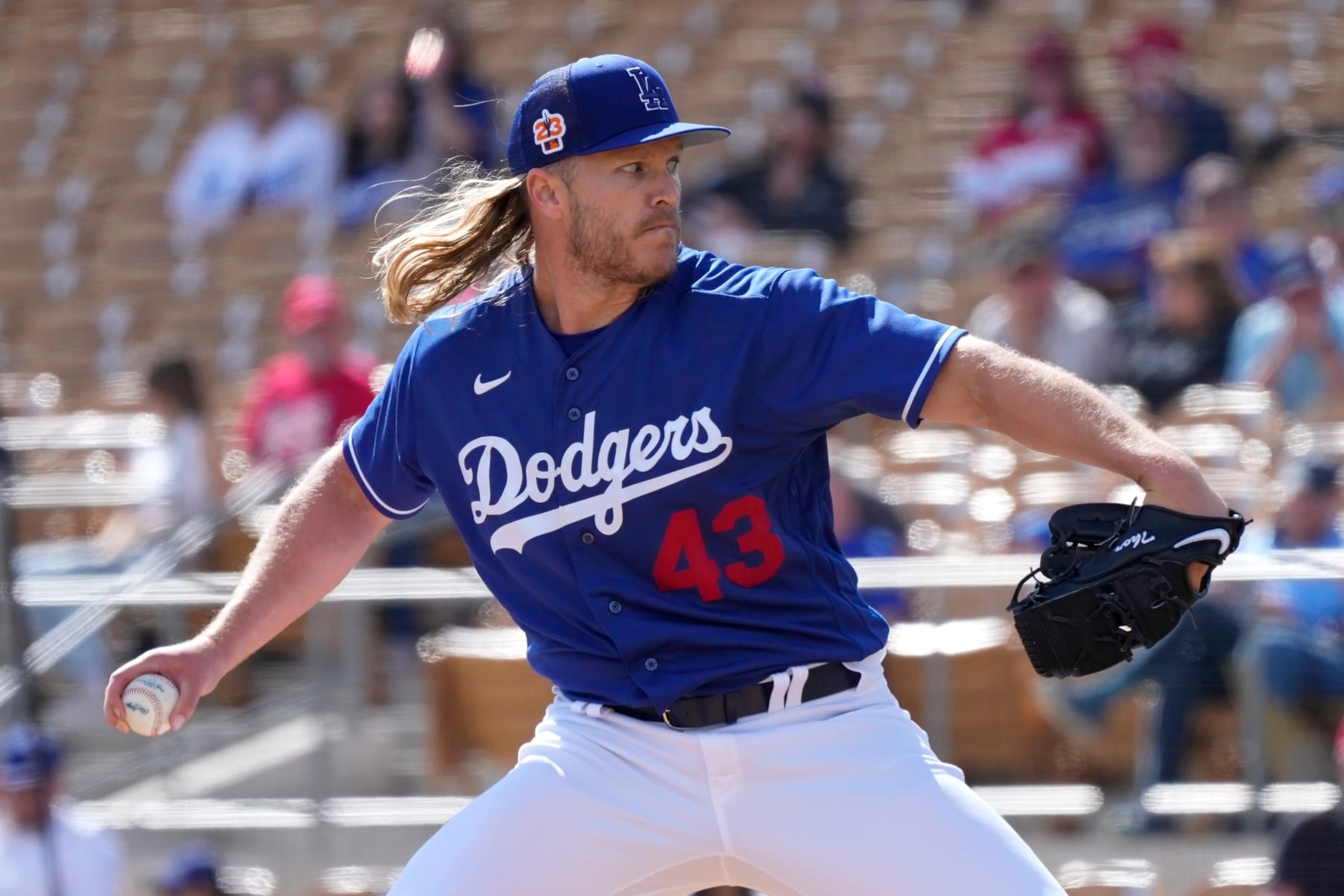 Los Angeles Dodgers pitcher Noah Syndergaard throws a pitch against the Cincinnati Reds during the fourth inning of a spring training baseball game Tuesday, Feb. 28, 2023, in Phoenix. (AP Photo/Ross D. Franklin)