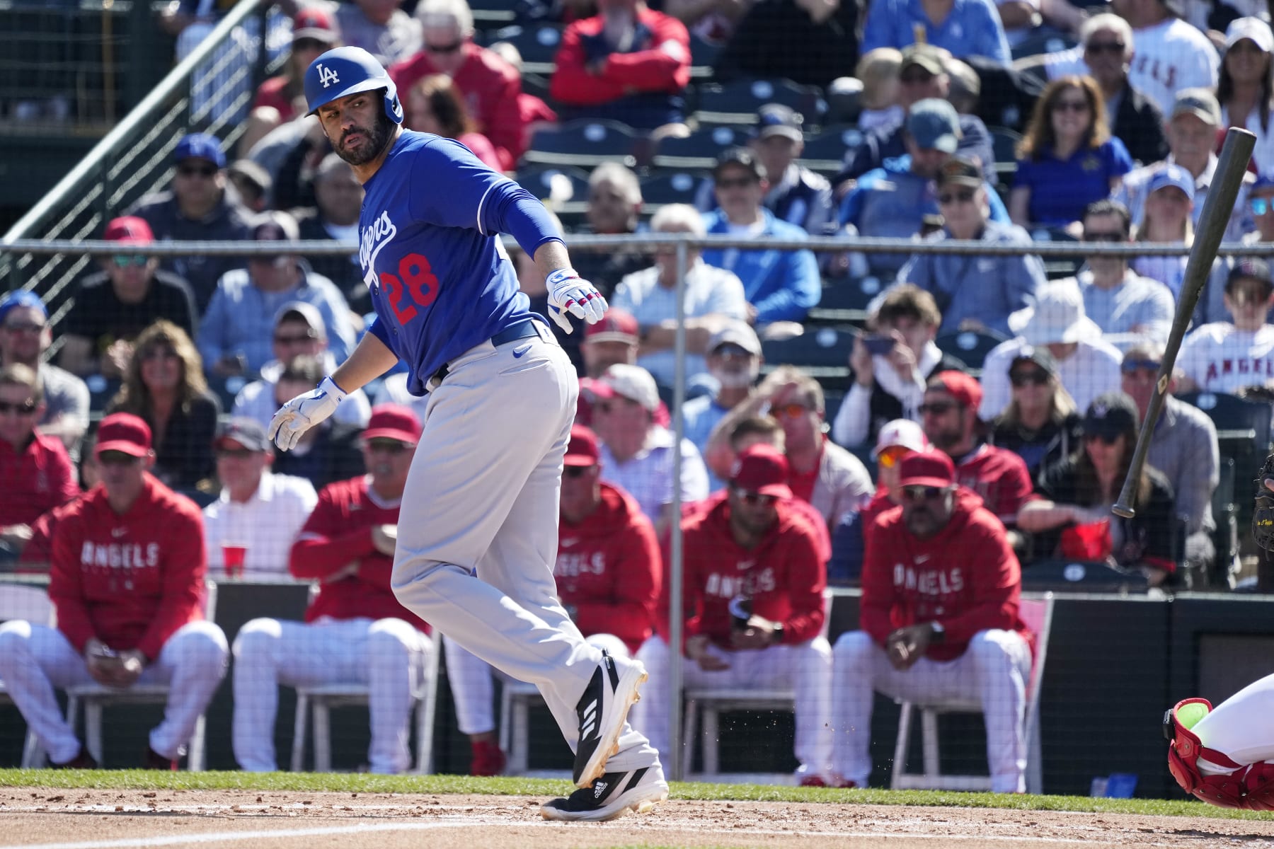 Los Angeles Dodgers designated hitter J.D. Martinez tosses his bat away after earning a walk against the Los Angeles Angels during the second inning of a spring training baseball game Friday, March 3, 2023, in Tempe, Ariz. (AP Photo/Ross D. Franklin)