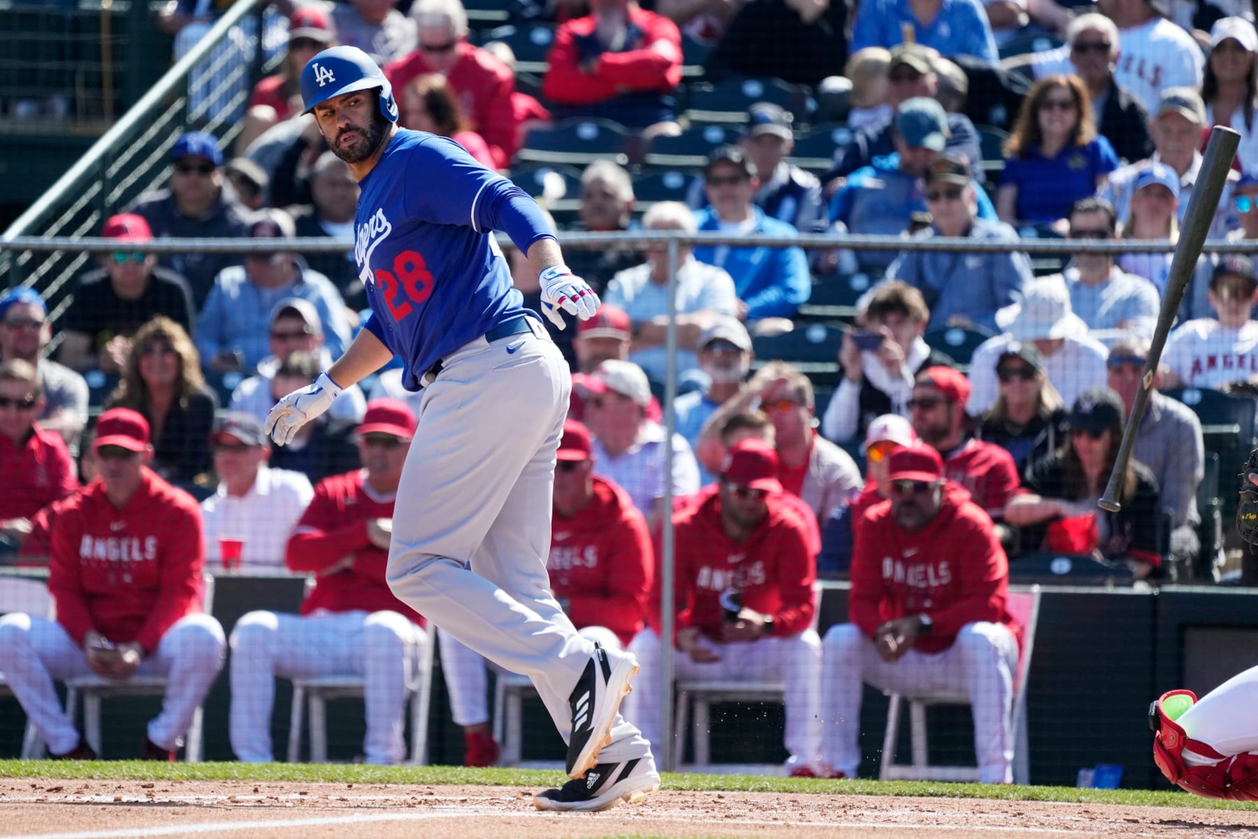 Los Angeles Dodgers designated hitter J.D. Martinez tosses his bat away after earning a walk against the Los Angeles Angels during the second inning of a spring training baseball game Friday, March 3, 2023, in Tempe, Ariz. (AP Photo/Ross D. Franklin)