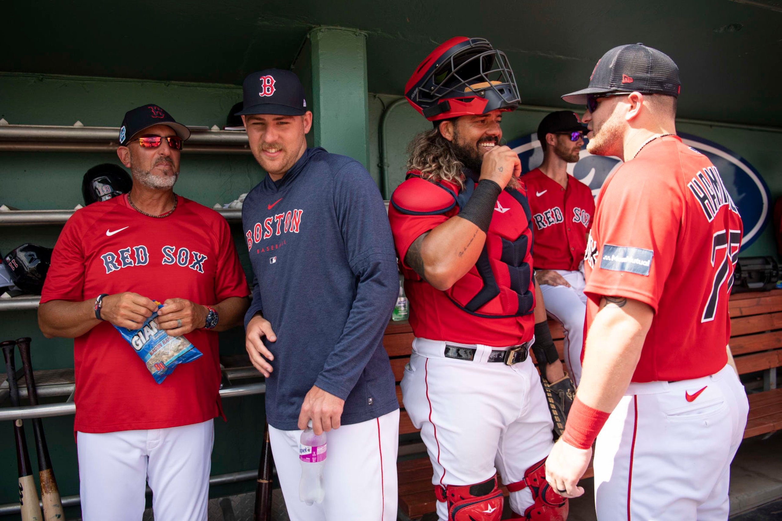 FORT MYERS, FL - MARCH 6:  José Flores, Josh Winckowski #73 of the Boston Red Sox, Jorge Alfaro #38 of the Boston Red Sox, and Caleb Hamilton #77 of the Boston Red Sox react in the dugout before a Grapefruit League game against the Detroit Tigers on March 6, 2023 at JetBlue Park at Fenway South in Fort Myers, Florida. (Photo by Maddie Malhotra/Boston Red Sox/Getty Images)