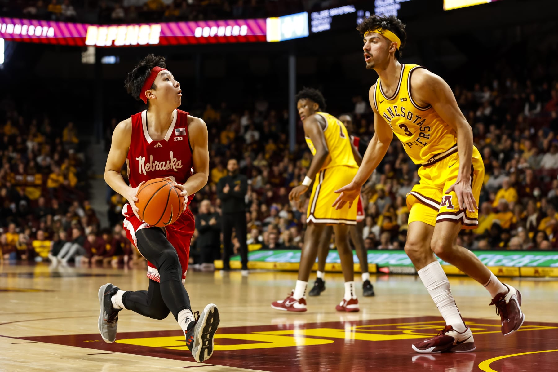 MINNEAPOLIS, MN - JANUARY 07: Keisei Tominaga #30 of the Nebraska Cornhuskers drives to the basket while Dawson Garcia #3 of the Minnesota Golden Gophers defends in the second half of the game at Williams Arena on January 7, 2023 in Minneapolis, Minnesota. The Cornhuskers defeated the Golden Gophers 81-79 in overtime. (Photo by David Berding/Getty Images)