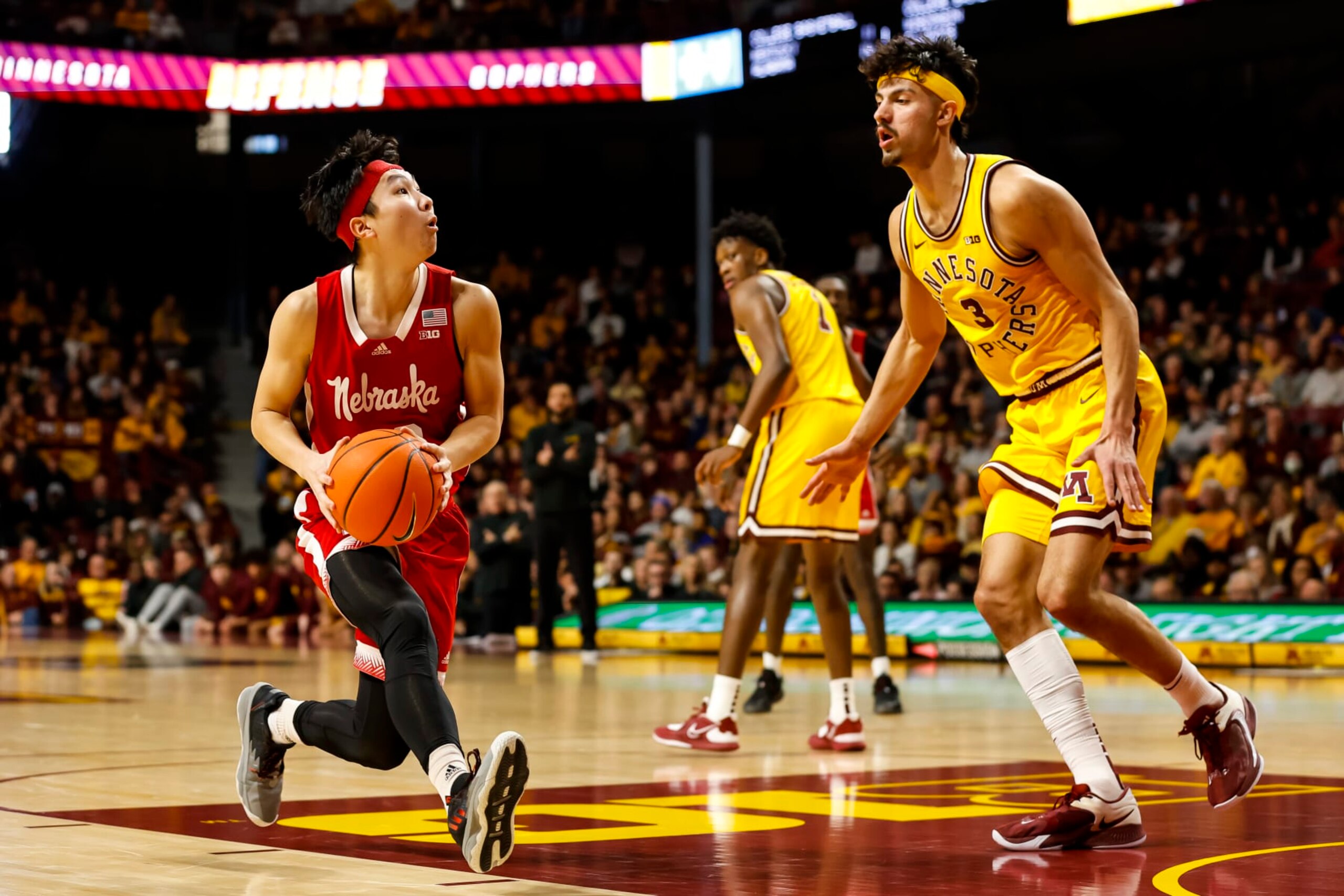 MINNEAPOLIS, MN - JANUARY 07: Keisei Tominaga #30 of the Nebraska Cornhuskers drives to the basket while Dawson Garcia #3 of the Minnesota Golden Gophers defends in the second half of the game at Williams Arena on January 7, 2023 in Minneapolis, Minnesota. The Cornhuskers defeated the Golden Gophers 81-79 in overtime. (Photo by David Berding/Getty Images)