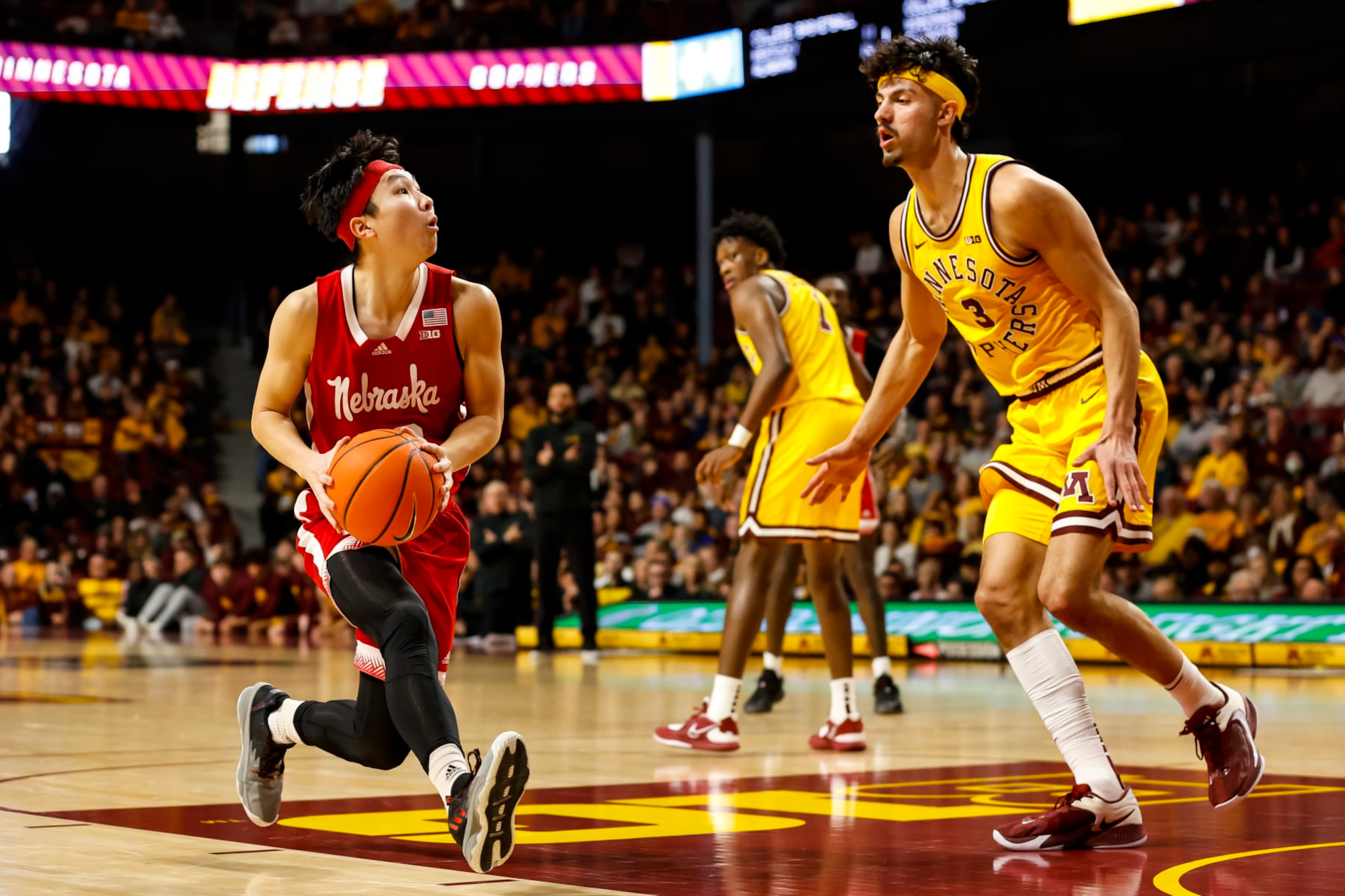 MINNEAPOLIS, MN - JANUARY 07: Keisei Tominaga #30 of the Nebraska Cornhuskers drives to the basket while Dawson Garcia #3 of the Minnesota Golden Gophers defends in the second half of the game at Williams Arena on January 7, 2023 in Minneapolis, Minnesota. The Cornhuskers defeated the Golden Gophers 81-79 in overtime. (Photo by David Berding/Getty Images)
