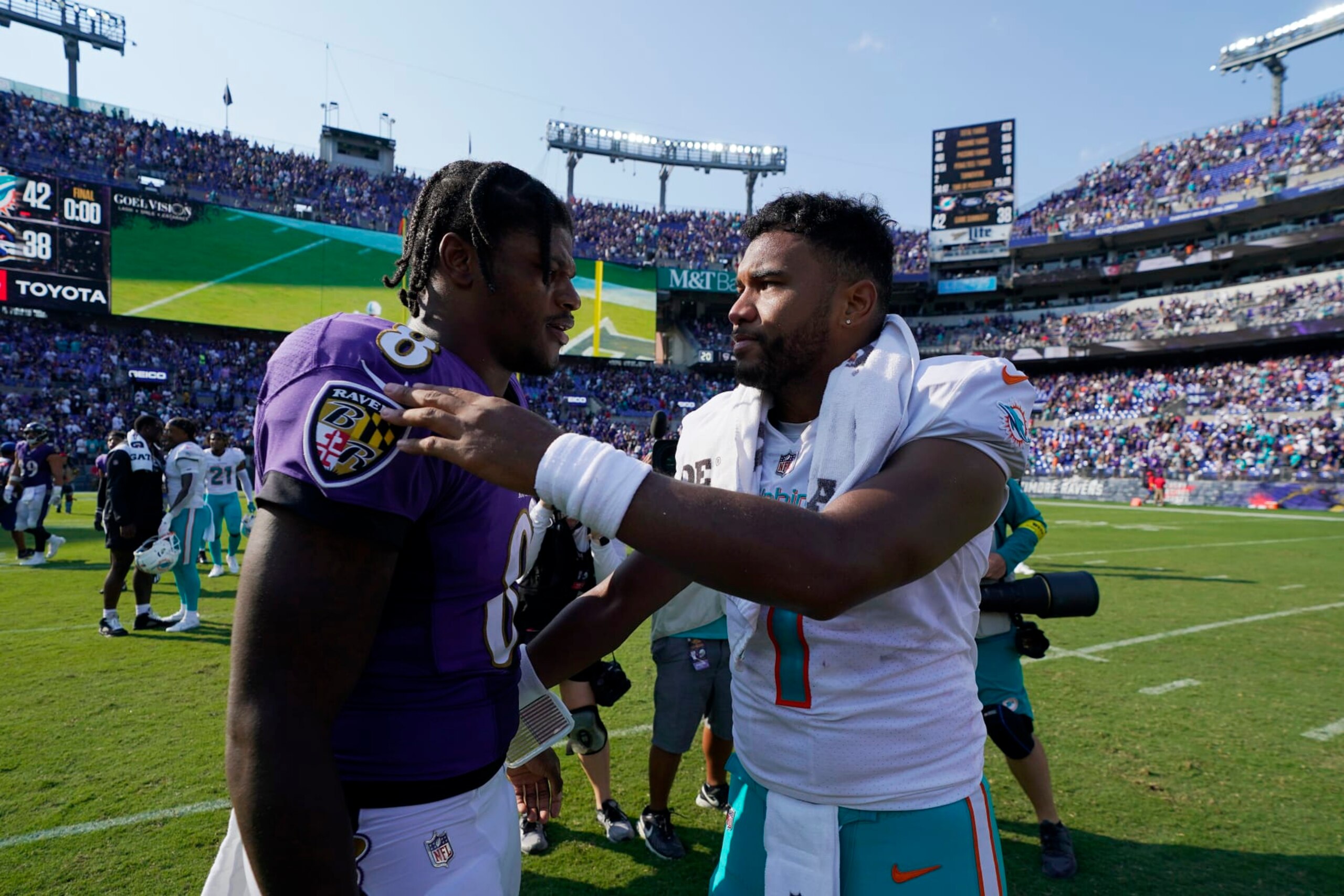 Miami Dolphins quarterback Tua Tagovailoa and Baltimore Ravens quarterback Lamar Jackson greet each other at the end of an NFL football game, Sunday, Sept. 18, 2022, in Baltimore. The Dolphins defeated the Ravens 42-38. (AP Photo/Julio Cortez)