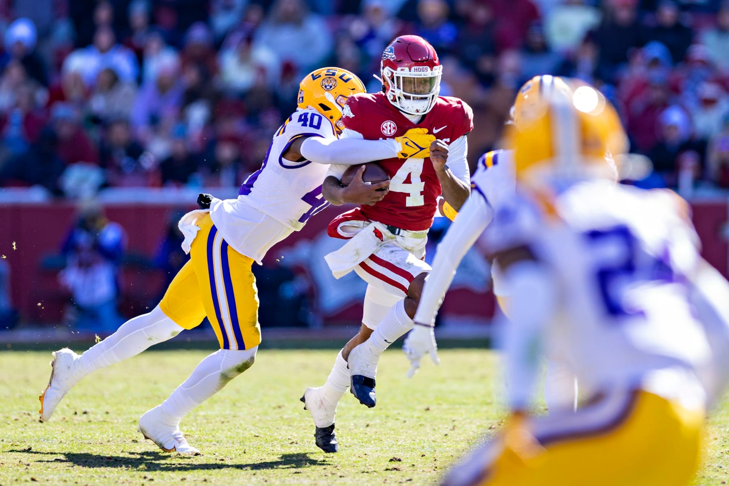 FAYETTEVILLE, ARKANSAS - NOVEMBER 12: Malik Hornsby #4 of the Arkansas Razorbacks runs the ball and is tackled by Harold Perkins Jr. #40 of the LSU Tigers at Donald W. Reynolds Razorback Stadium on November 12, 2022 in Fayetteville, Arkansas. The Tigers defeated the Razorbacks 13-10. (Photo by Wesley Hitt/Getty Images)