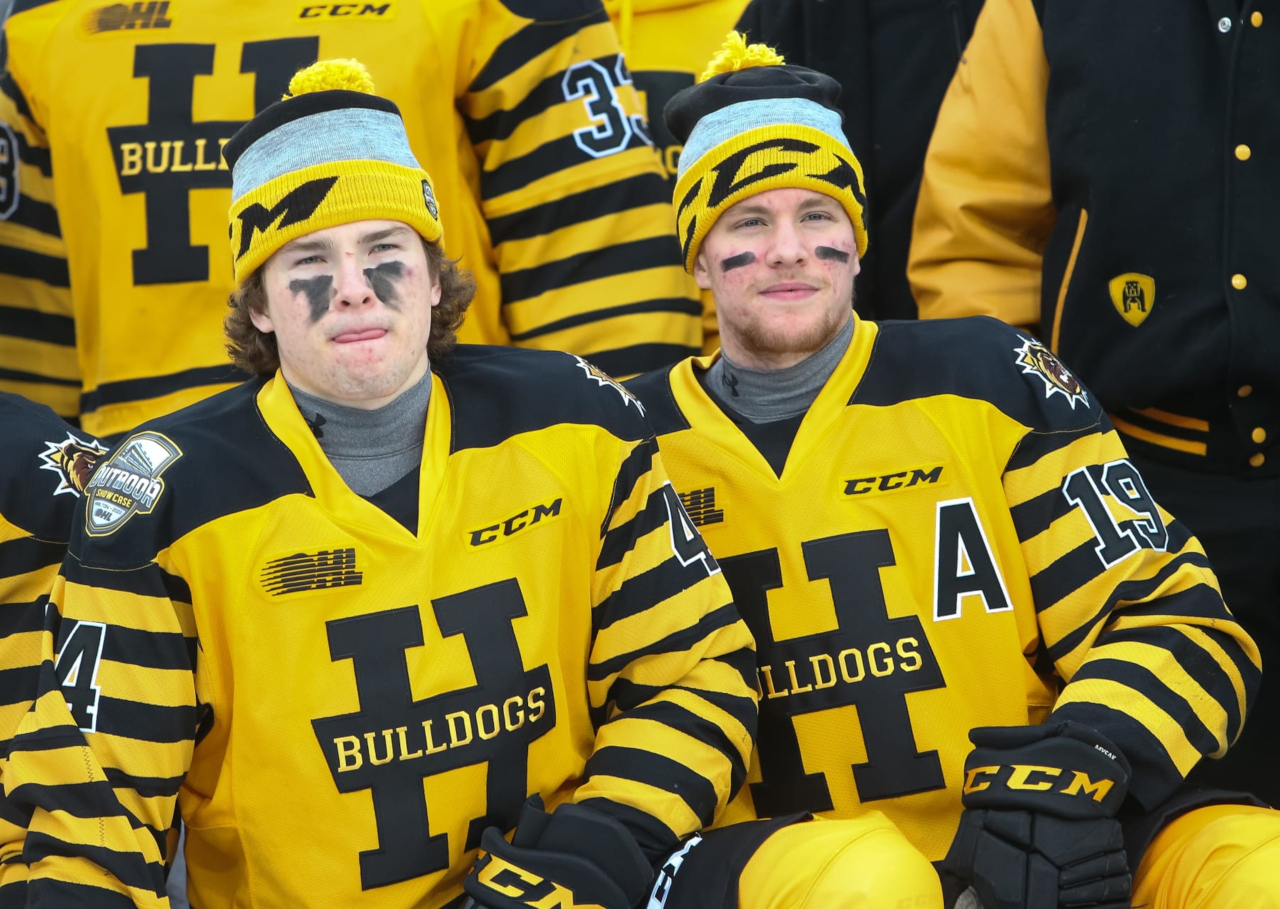 HAMILTON, ONTARIO - MARCH 14: Nathan Staios #44 of the Hamilton Bulldogs and Jan Mysak #19 pose for a photo prior to the OHL Outdoor Showcase game against the Oshawa Generals at Tim Hortons Field on March 14, 2022 in Hamilton, Ontario. (Photo by Chris Tanouye/Getty Images)