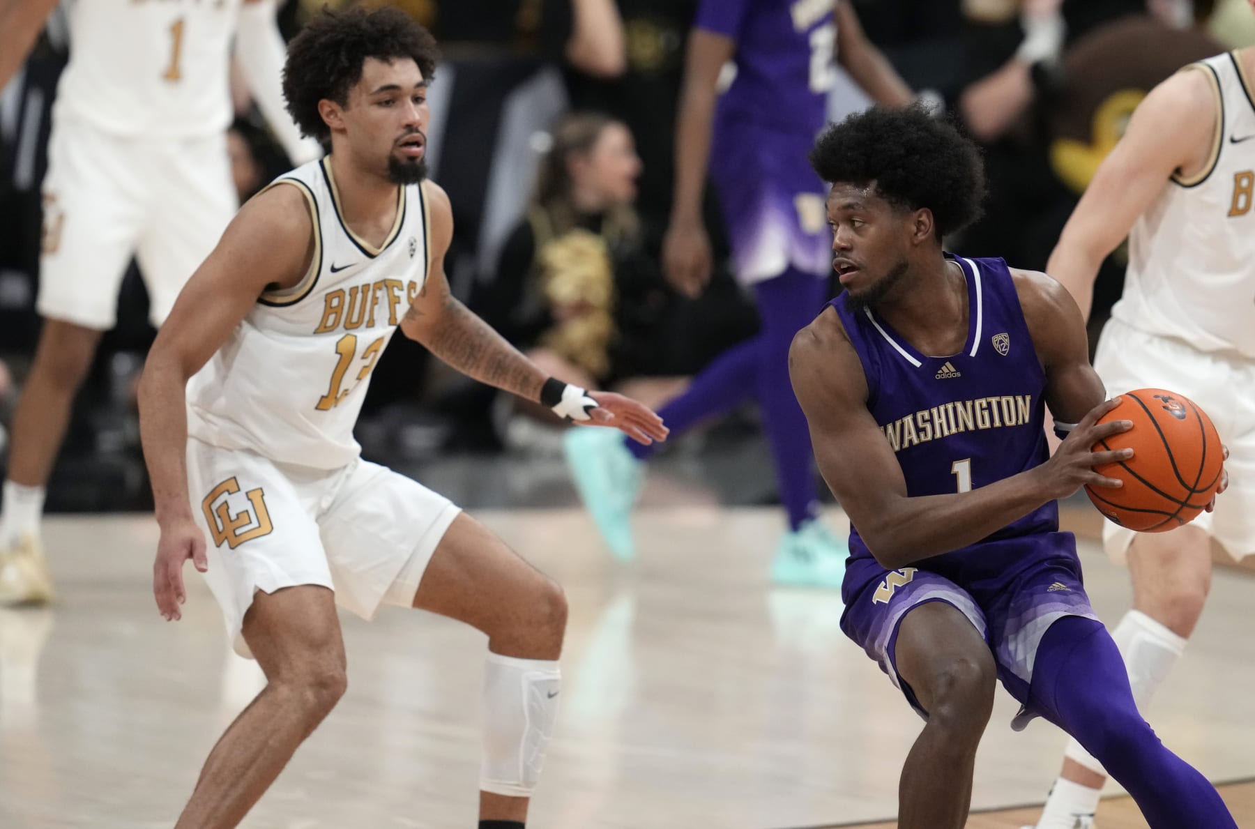 Washington forward Keion Brooks (1) and Colorado guard J'Vonne Hadley (13) in the second half of an NCAA college basketball game Thursday, Jan. 19, 20223, in Boulder, Colo. (AP Photo/David Zalubowski)