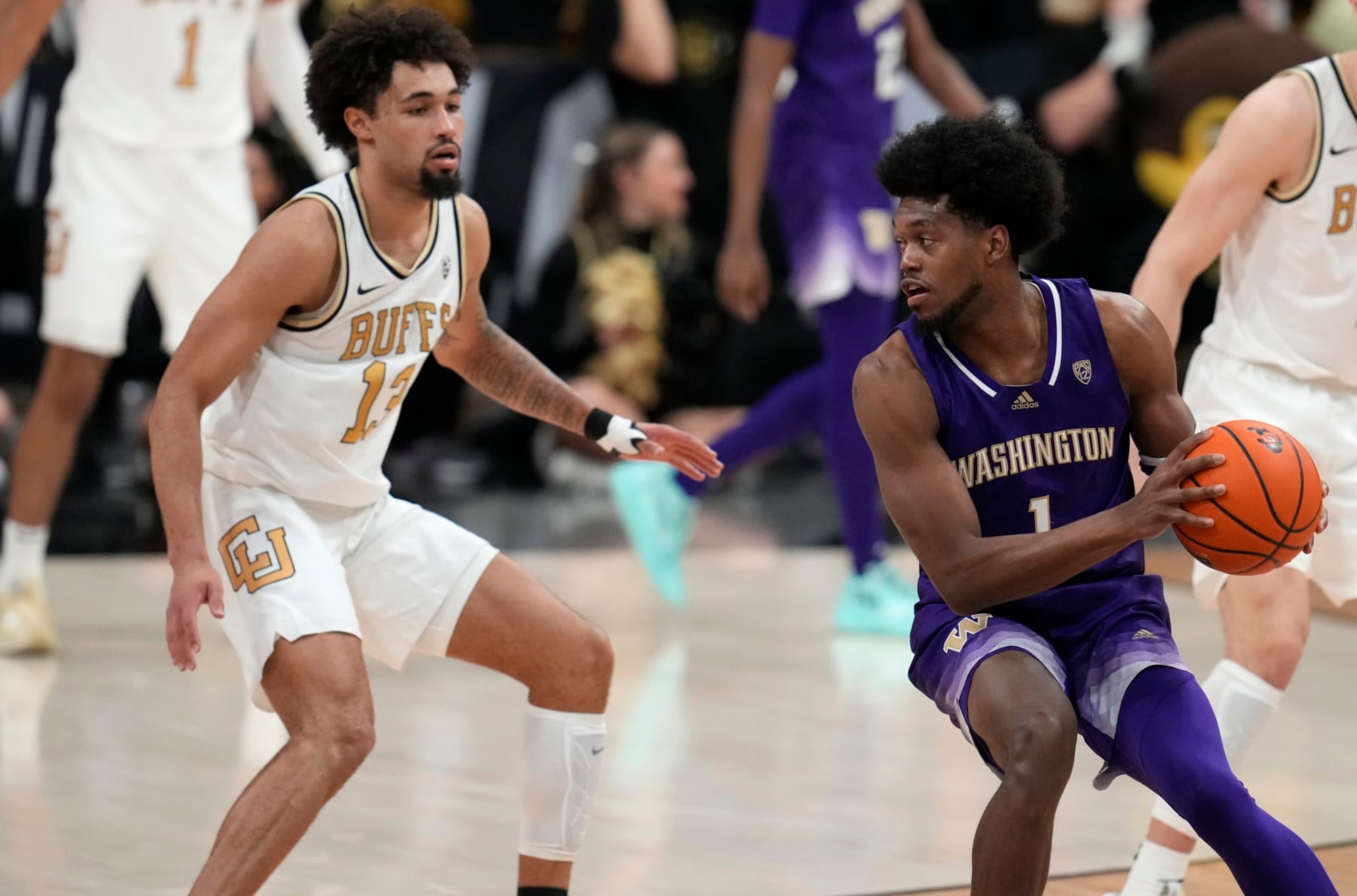 Washington forward Keion Brooks (1) and Colorado guard J'Vonne Hadley (13) in the second half of an NCAA college basketball game Thursday, Jan. 19, 20223, in Boulder, Colo. (AP Photo/David Zalubowski)
