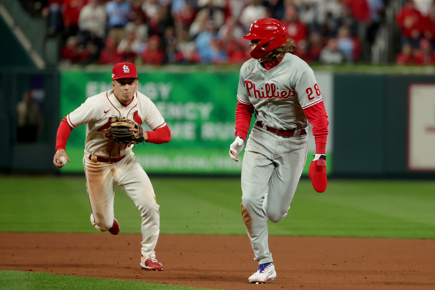 ST LOUIS, MISSOURI - OCTOBER 08: Alec Bohm #28 of the Philadelphia Phillies is caught in a rundown against Tommy Edman #19 of the St. Louis Cardinals during the sixth inning in game two of the National League Wild Card Series at Busch Stadium on October 08, 2022 in St Louis, Missouri. (Photo by Stacy Revere/Getty Images)