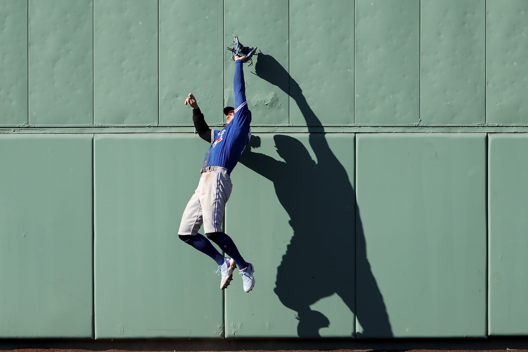 BOSTON, MA - JULY 23: George Springer #4 of the Toronto Blue Jays goes up to catch a ball hit by Xander Bogaerts #2 of the Boston Red Sox at the centerfield wall during the third inning at Fenway Park on July 23, 2022 in Boston, Massachusetts. (Photo By Winslow Townson/Getty Images)