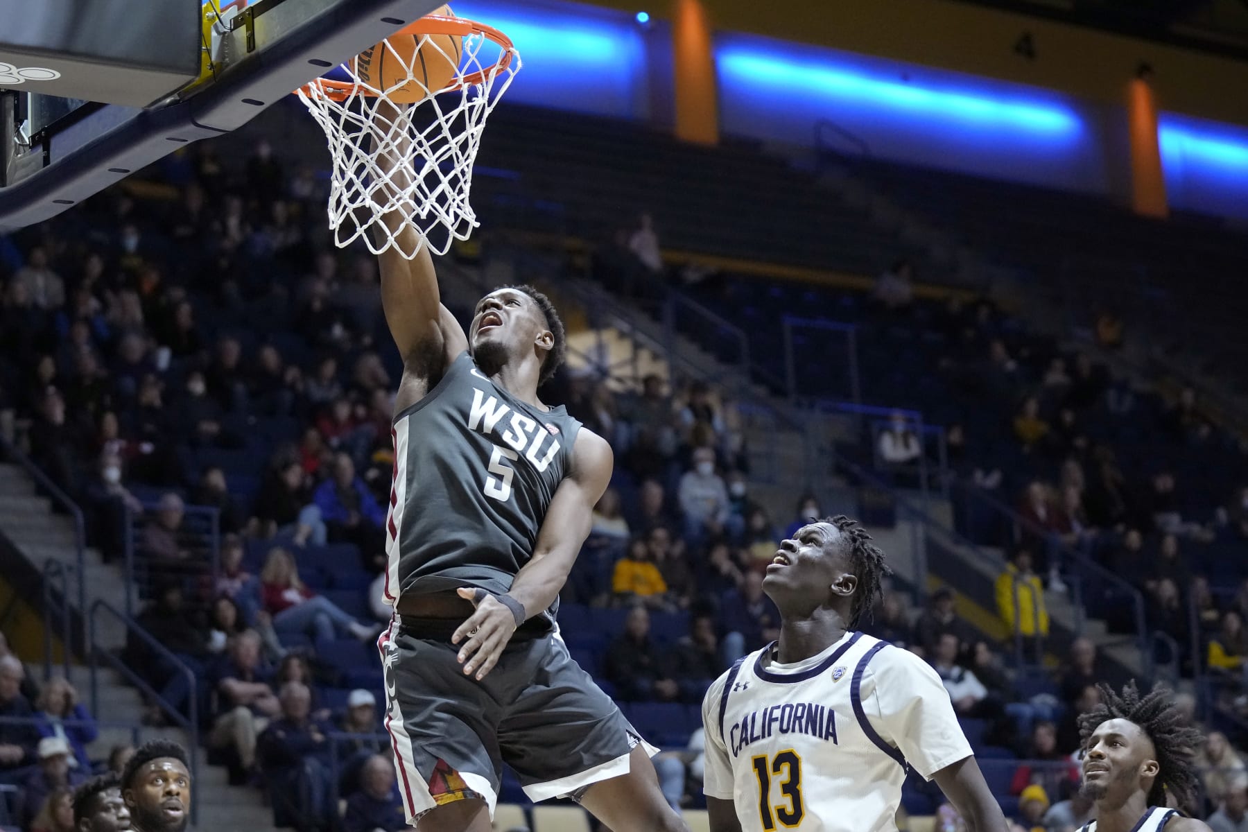 Washington State guard TJ Bamba (5) dunks in front of California forward Kuany Kuany (13) during the second half of an NCAA college basketball game in Berkeley, Calif., Saturday, Feb. 25, 2023. (AP Photo/Jeff Chiu)